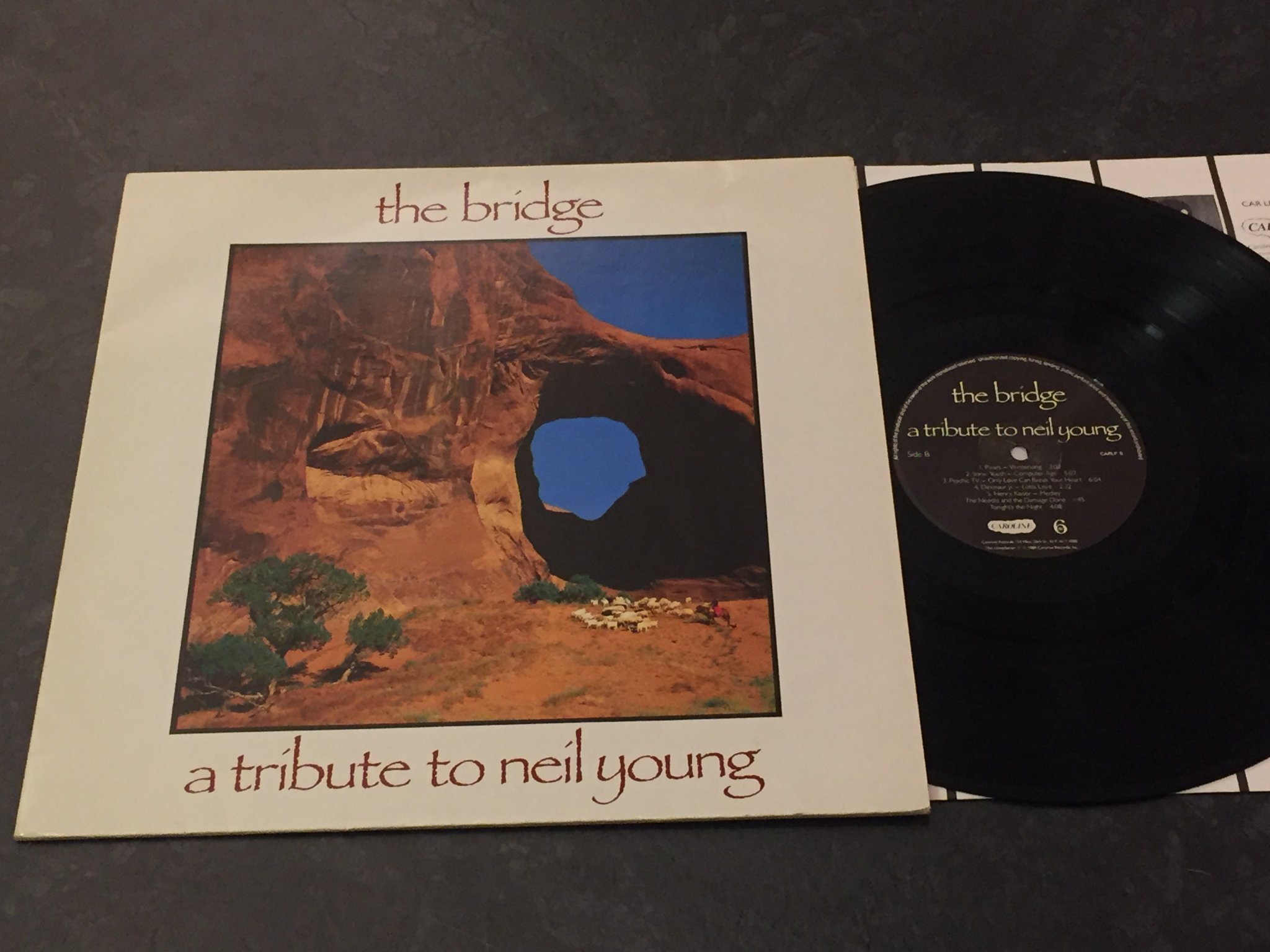 Omslagsbild för skivan THE BRIDGE a tribute to Neil Young LP -89 CAROLINE CAR LP 5