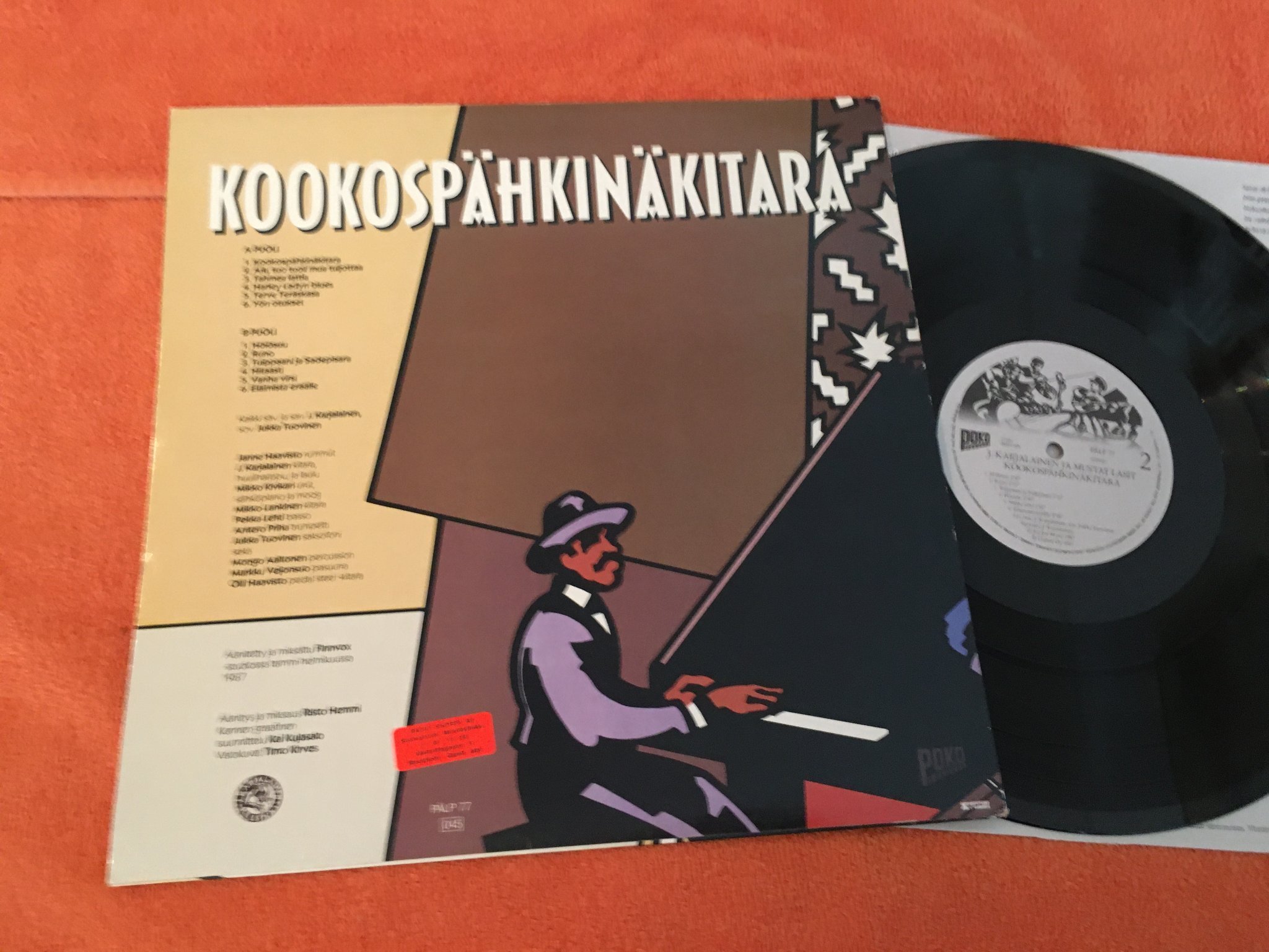 Omslagsbild för skivan J. Karjalainen Ja Mustat Lasit ?– Kookospähkinäkitara LP -87 Fin POKO PÄLP 77