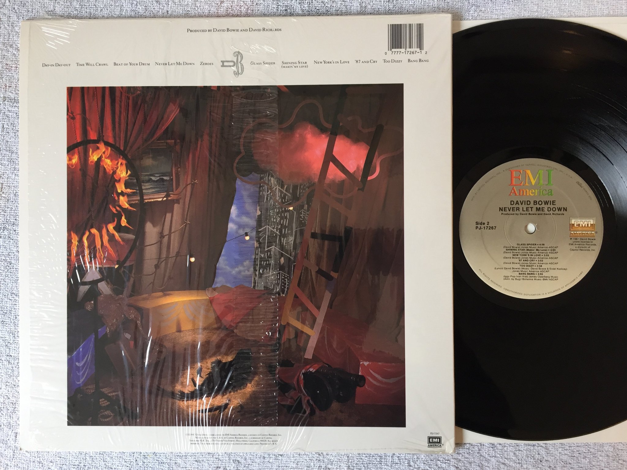 Omslagsbild för skivan DAVID BOWIE never let me down LP -87 US EMI PJ-17267 hyper sticker 