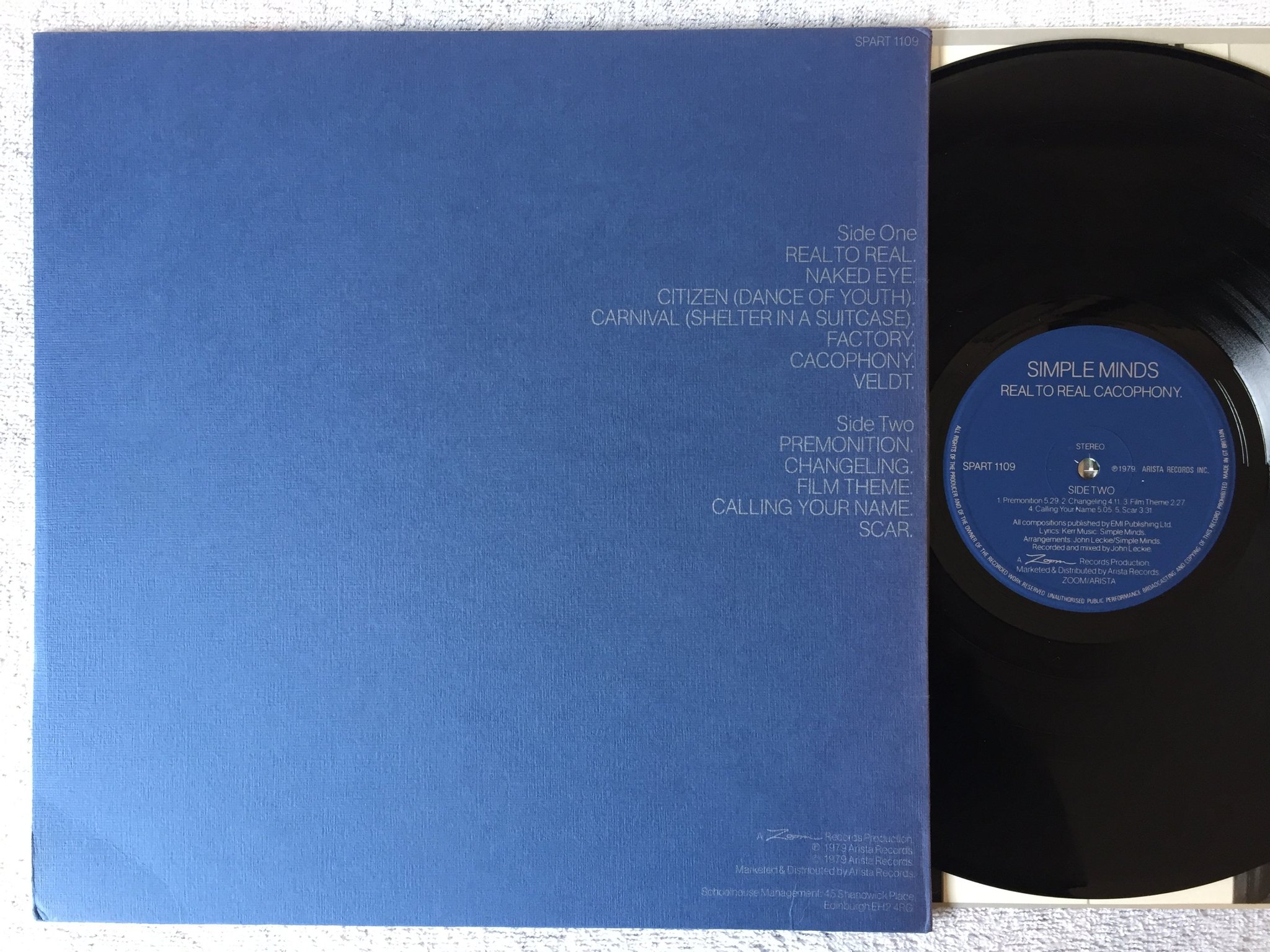 Omslagsbild för skivan SIMPLE MINDS Real To Real Cacophony LP -79 UK ZOOM SPART 1109 