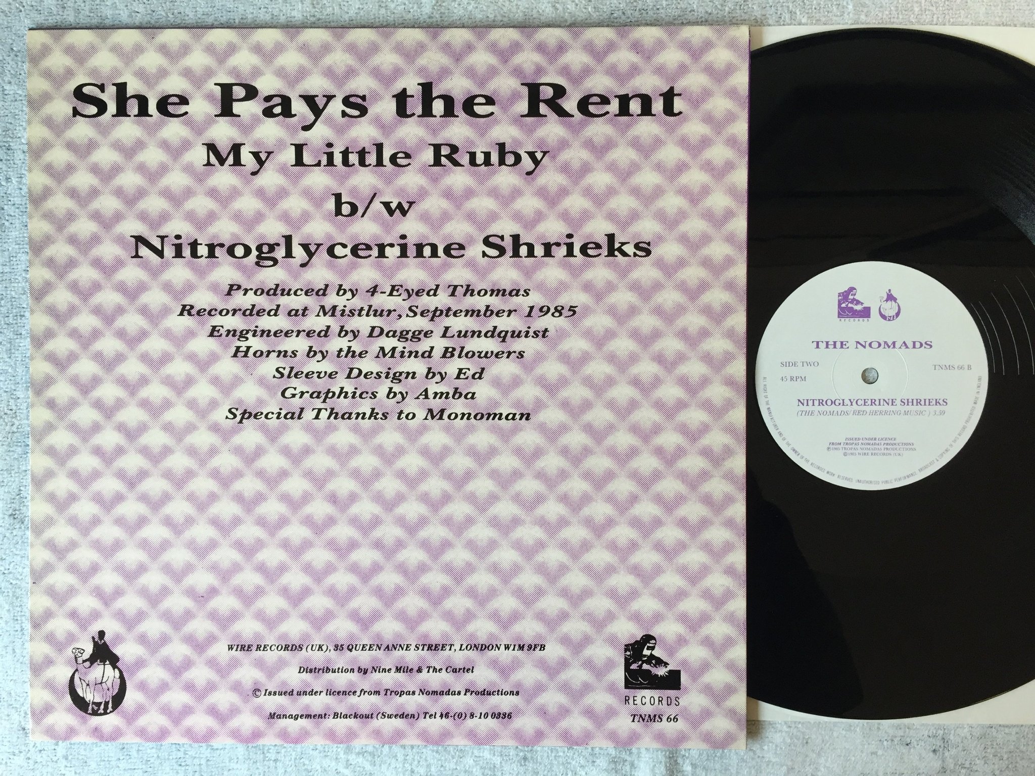Omslagsbild för skivan THE NOMADS She Pays The Rent 12"single -85 UK WIRE TNMS 66