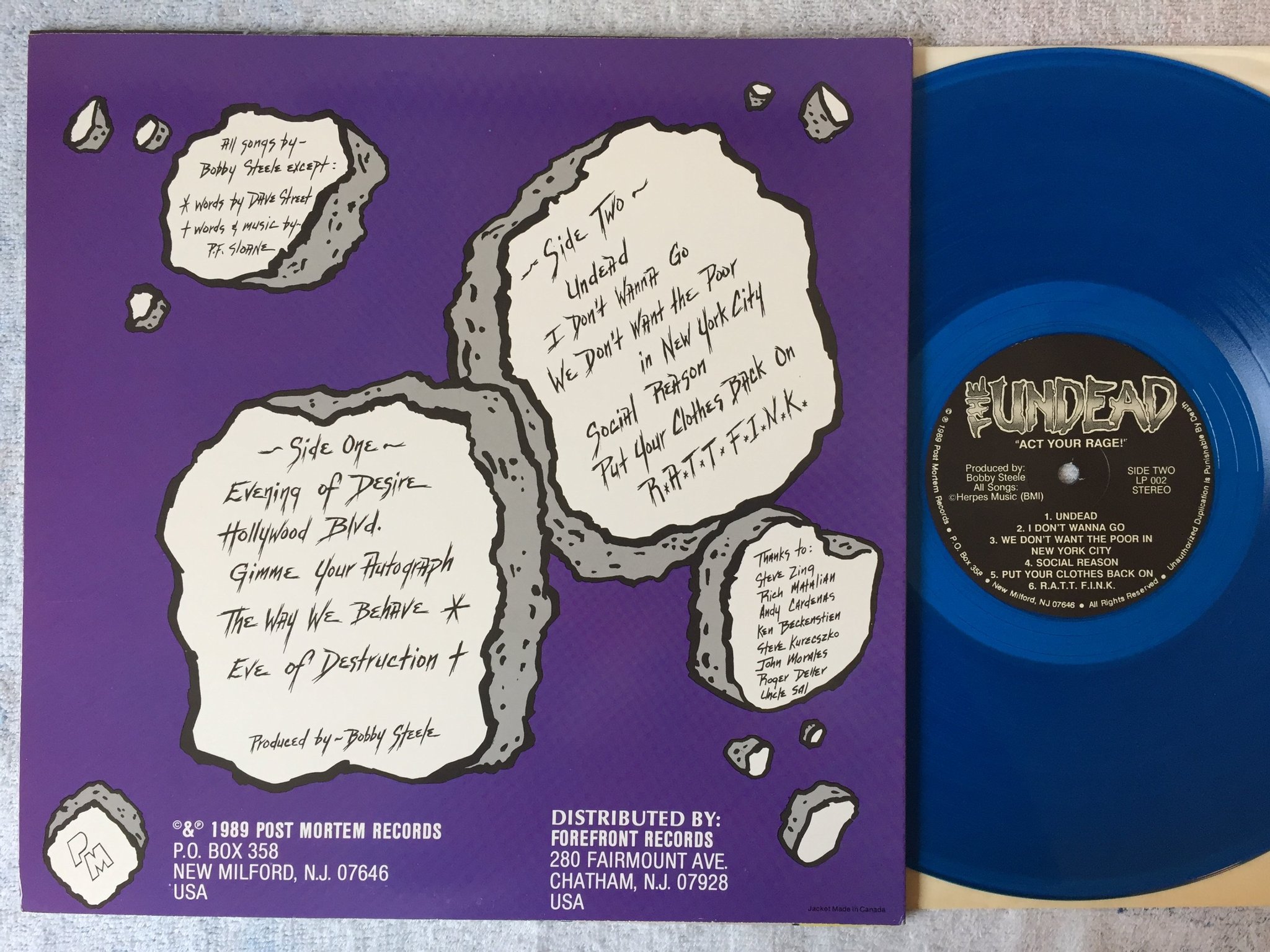 Omslagsbild för skivan THE UNDEAD act your rage LP -89 US POST MORTERN LP002 ltd blue vinyl PUNK!