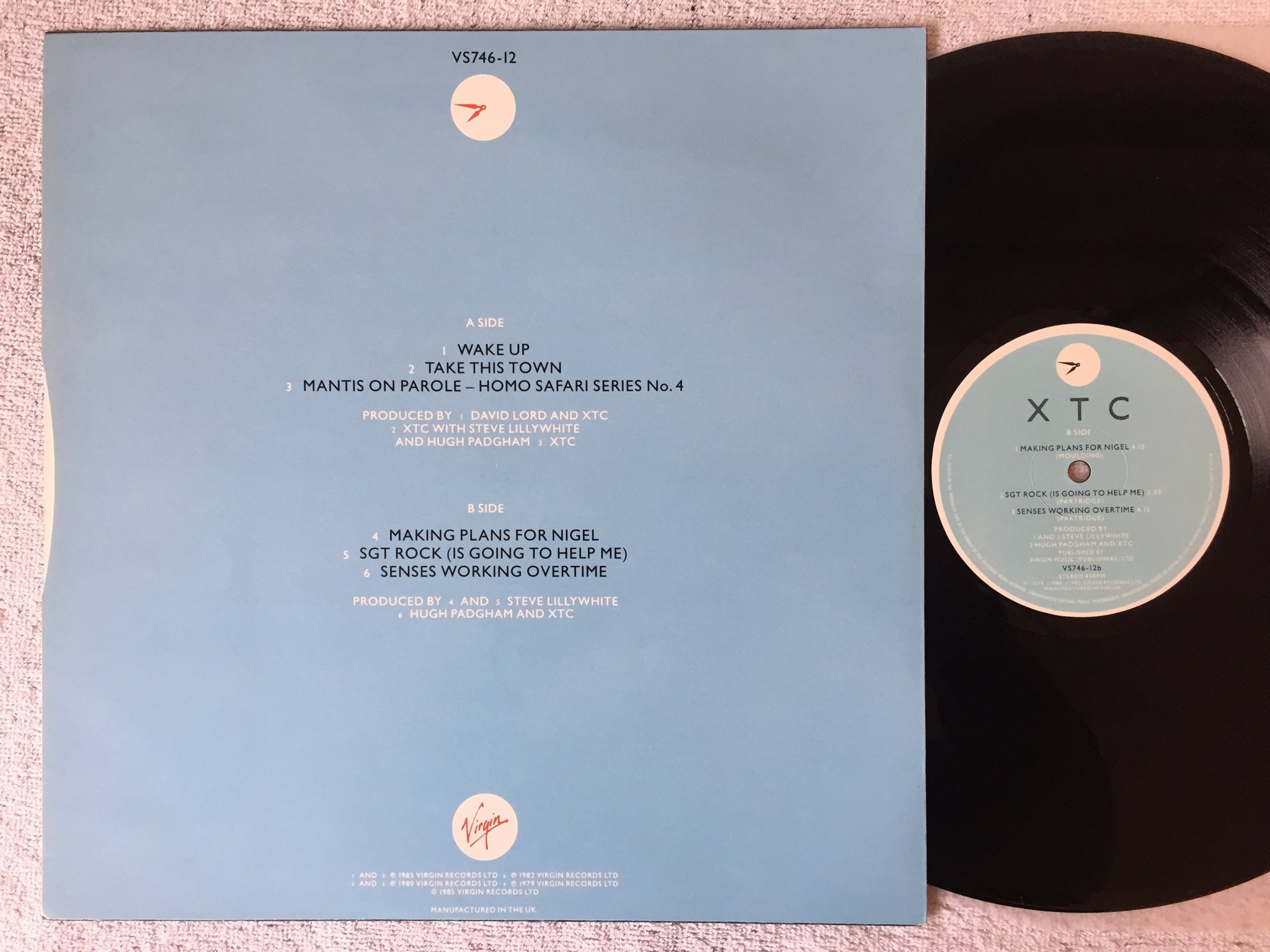 Omslagsbild för skivan XTC Wake Up 12"single -85 UK VIRGIN VS746-12