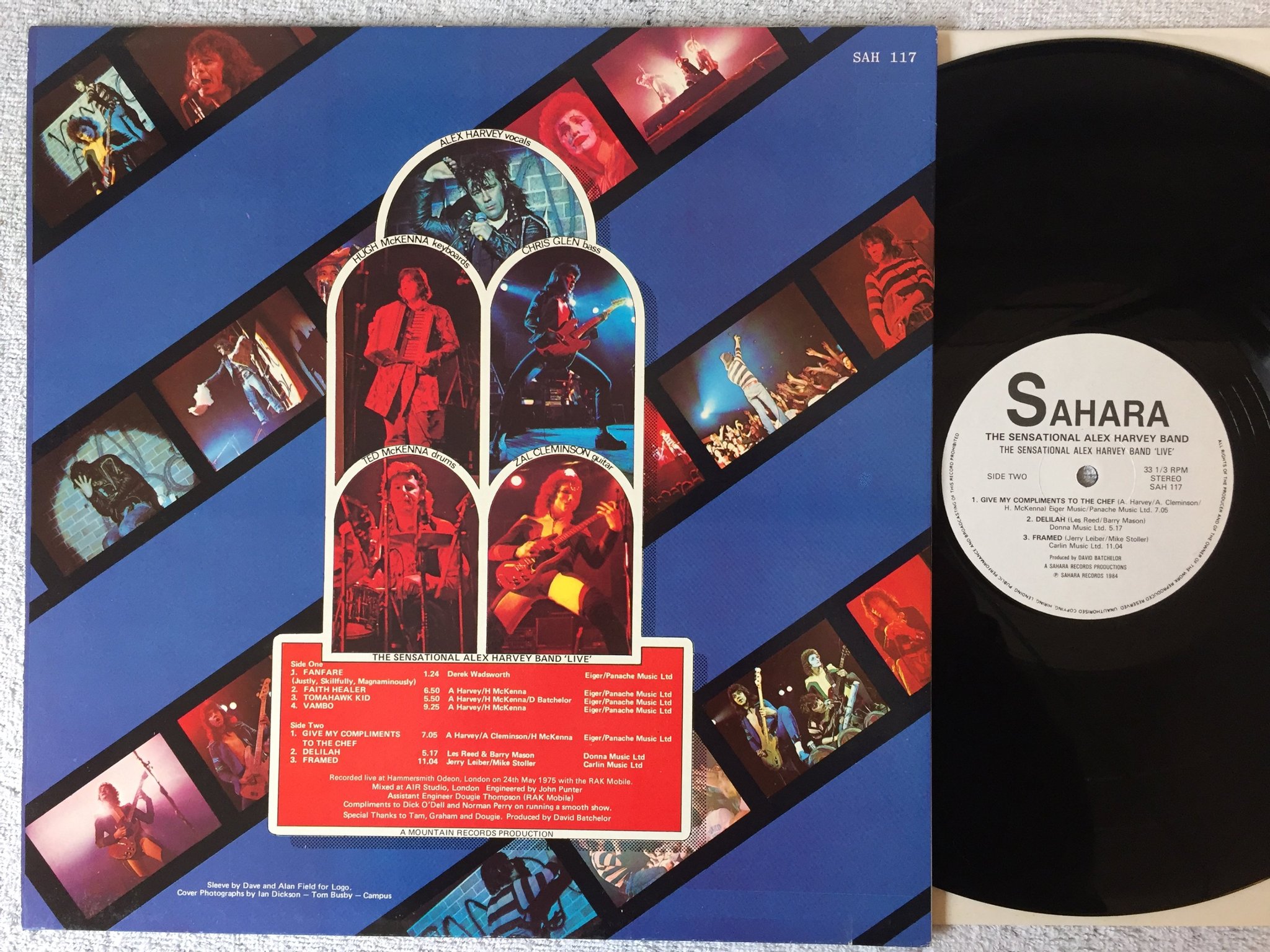 Omslagsbild för skivan THE SENSATIONAL ALEX HARVEY BAND "live" LP -84 SAHARA SAH 117