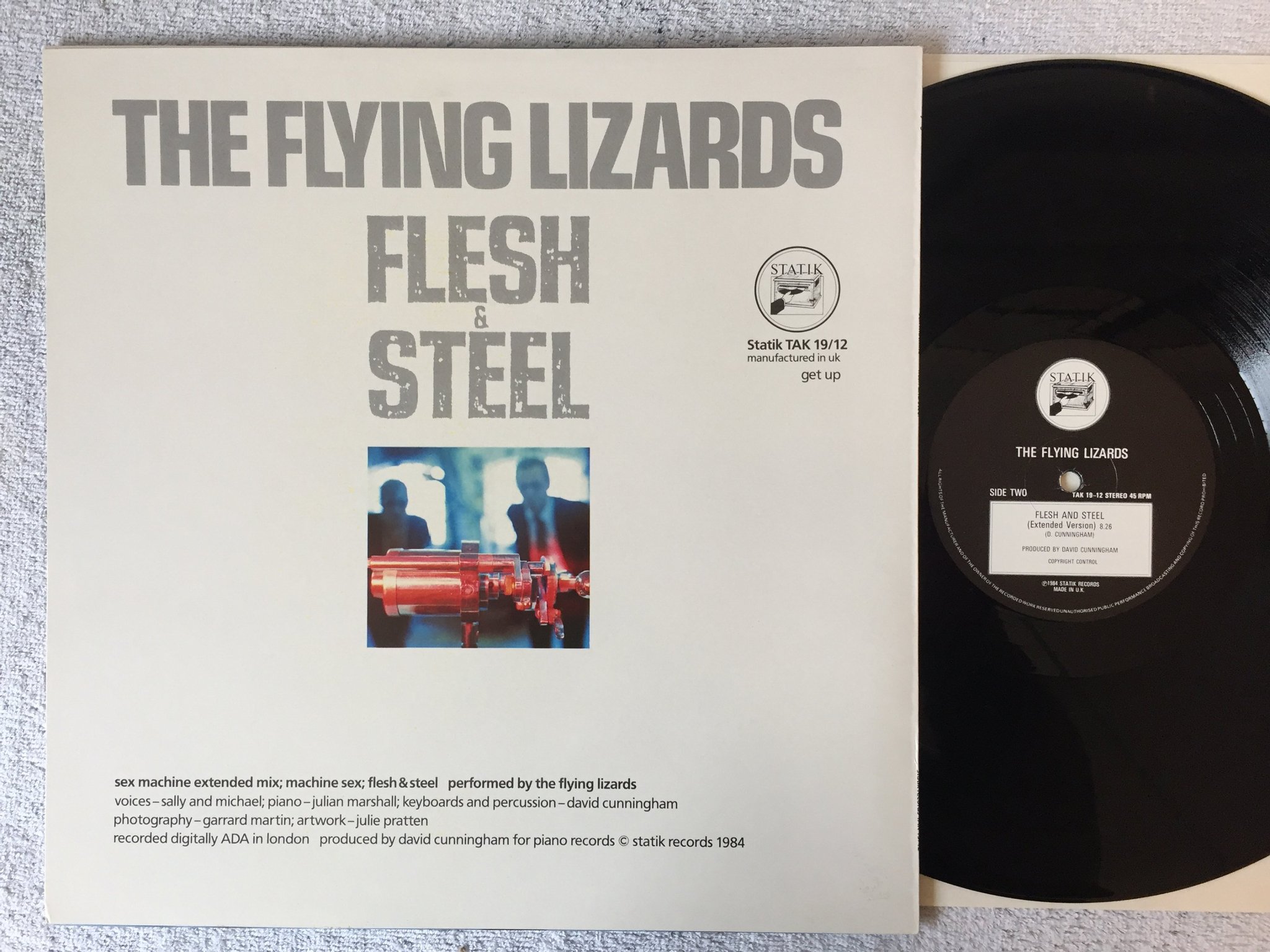 Omslagsbild för skivan The Flying Lizards – sex machine 12"Single -84 UK STATIK TAK 19/12