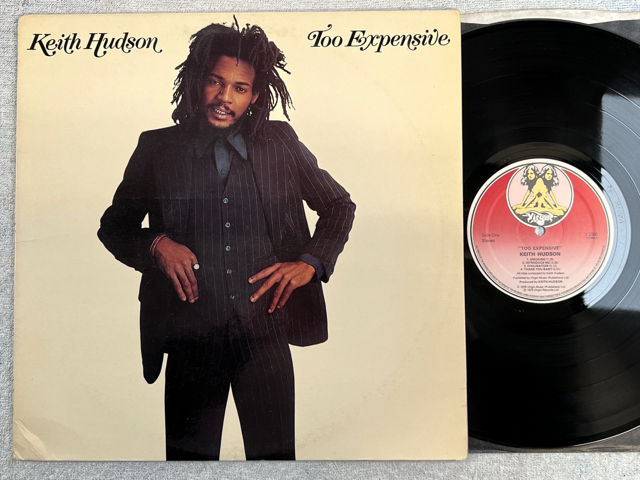 Omslagsbild för skivan KEITH HUDSON too expensive LP -76 UK VIRGIN V2056