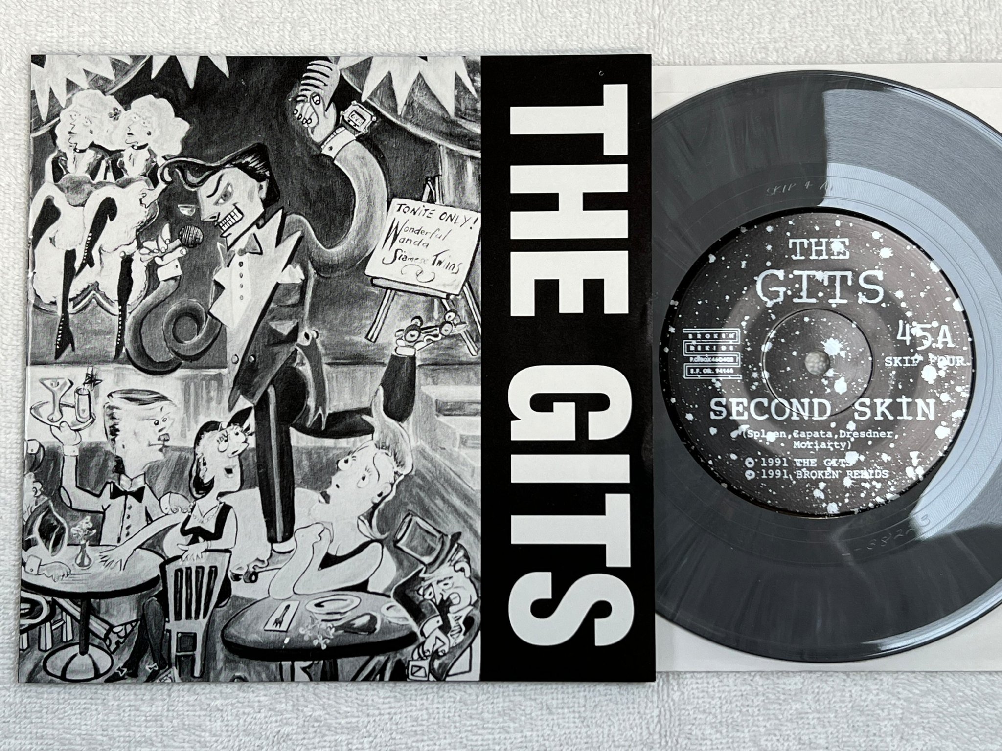 Omslagsbild för skivan THE GITS second skin 7"single -91 SKIP FOUR punk