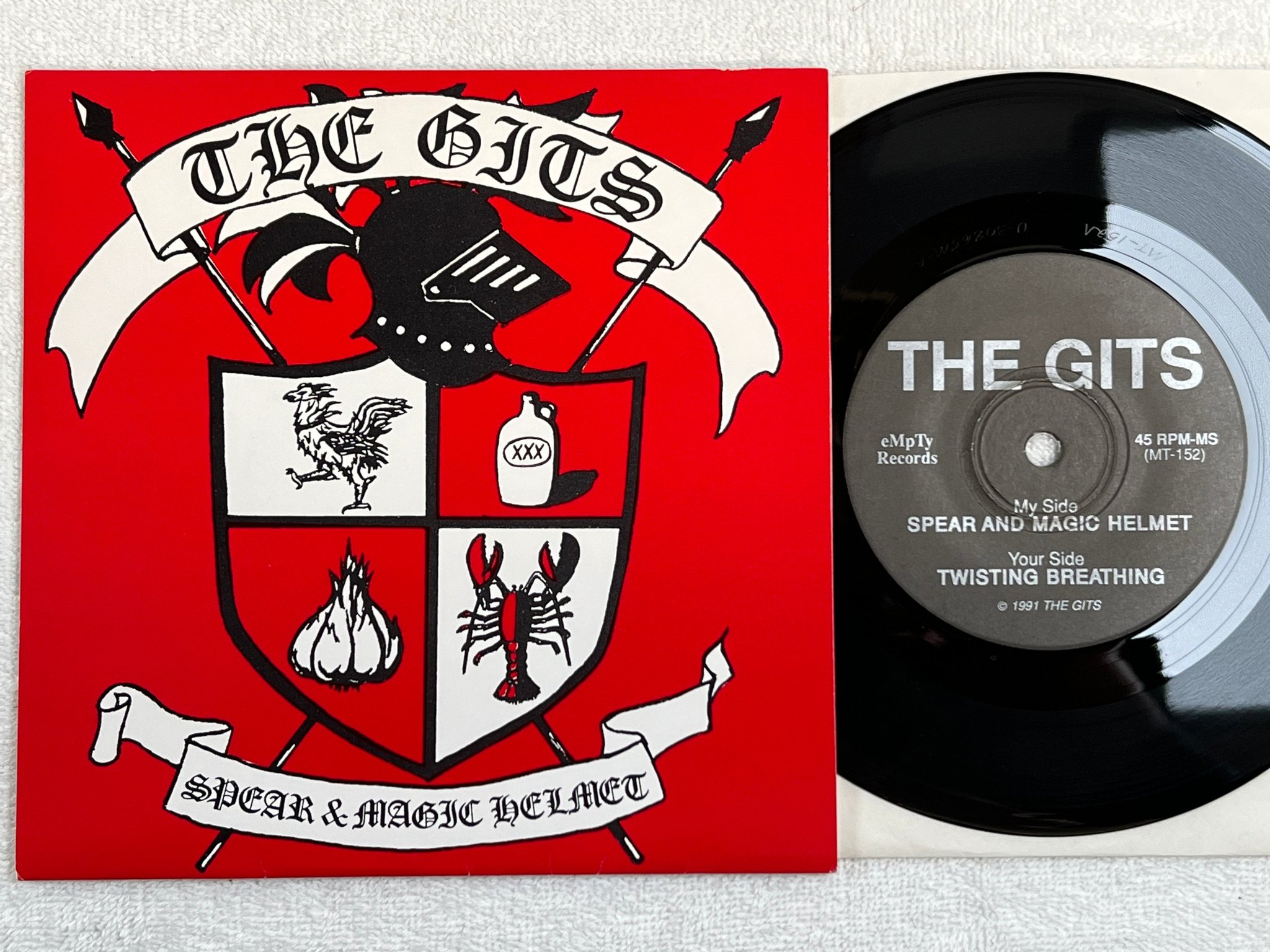 Omslagsbild för skivan THE GITS spear and magic helmet 7"single -91 MT-152