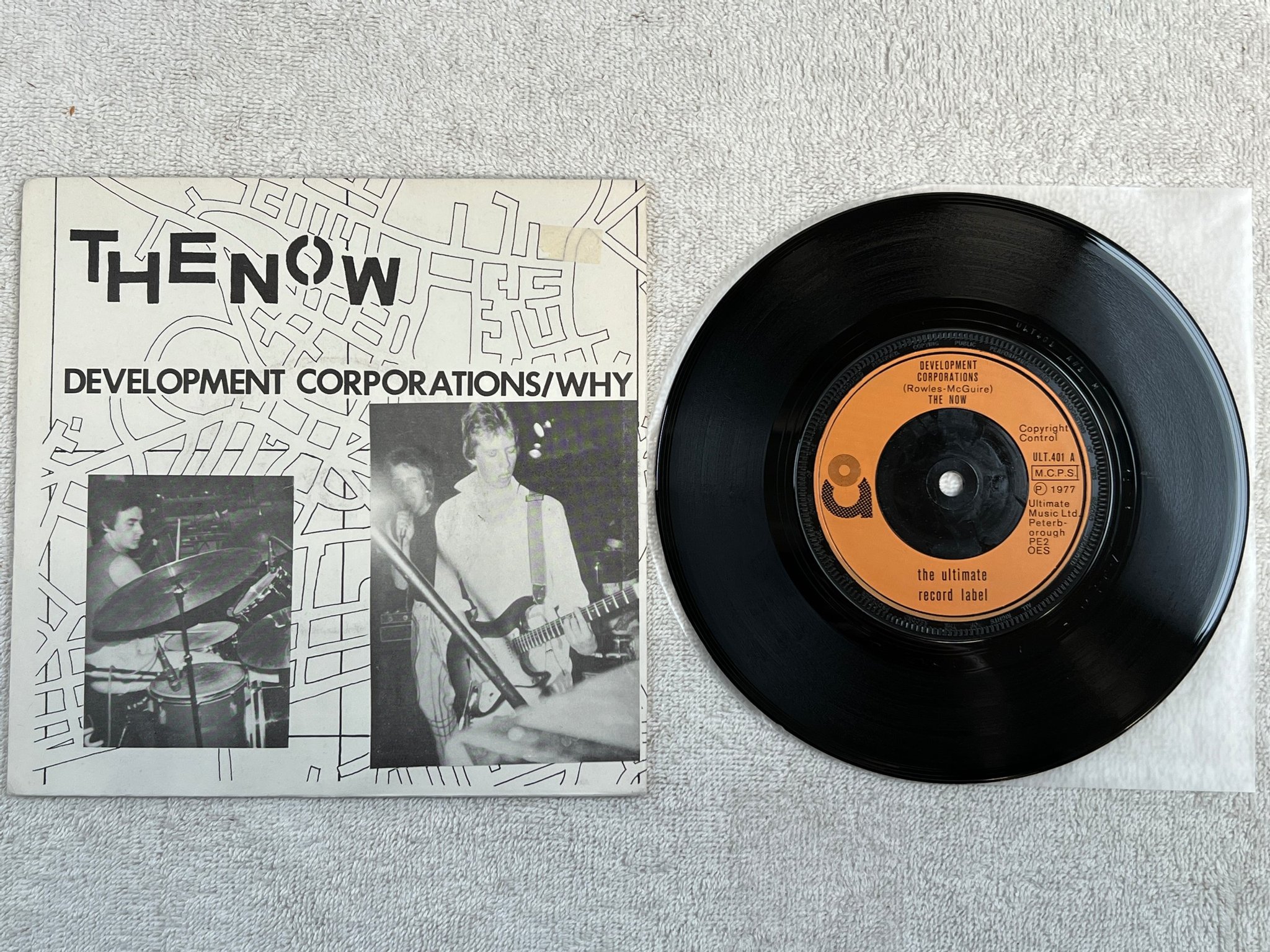 Omslagsbild för skivan THE NOW development corporations 7"single -77 UK ULTIMATE ULT 401 punk