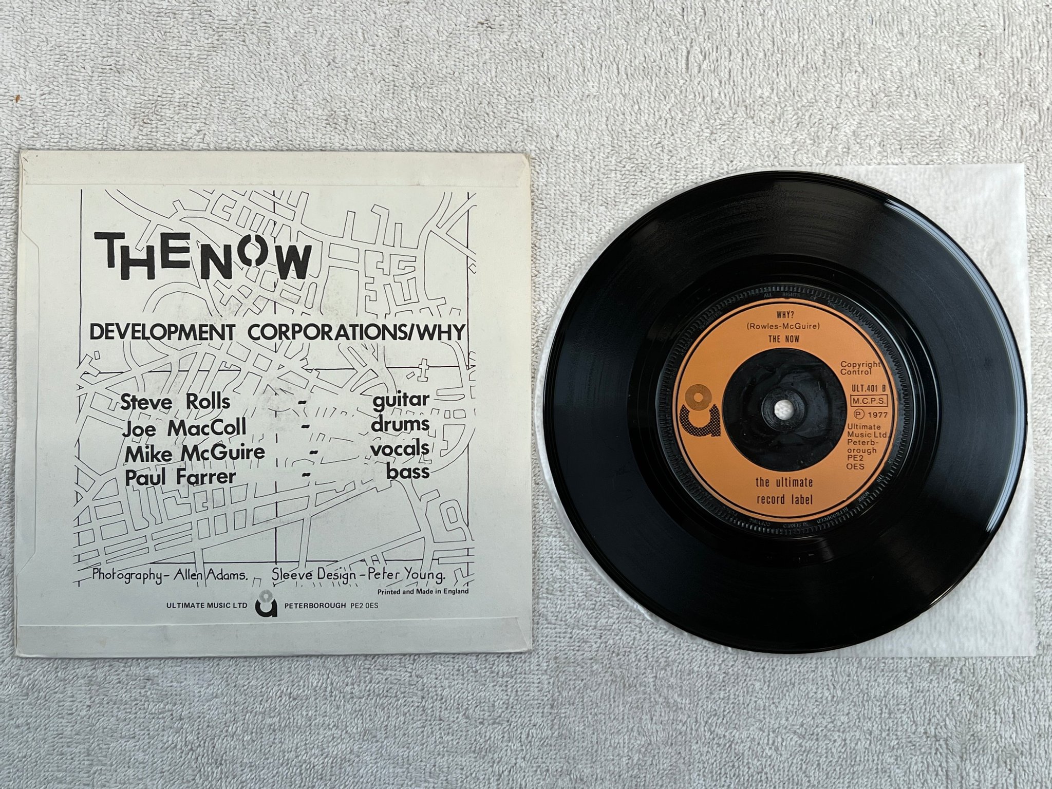 Omslagsbild för skivan THE NOW development corporations 7"single -77 UK ULTIMATE ULT 401 punk