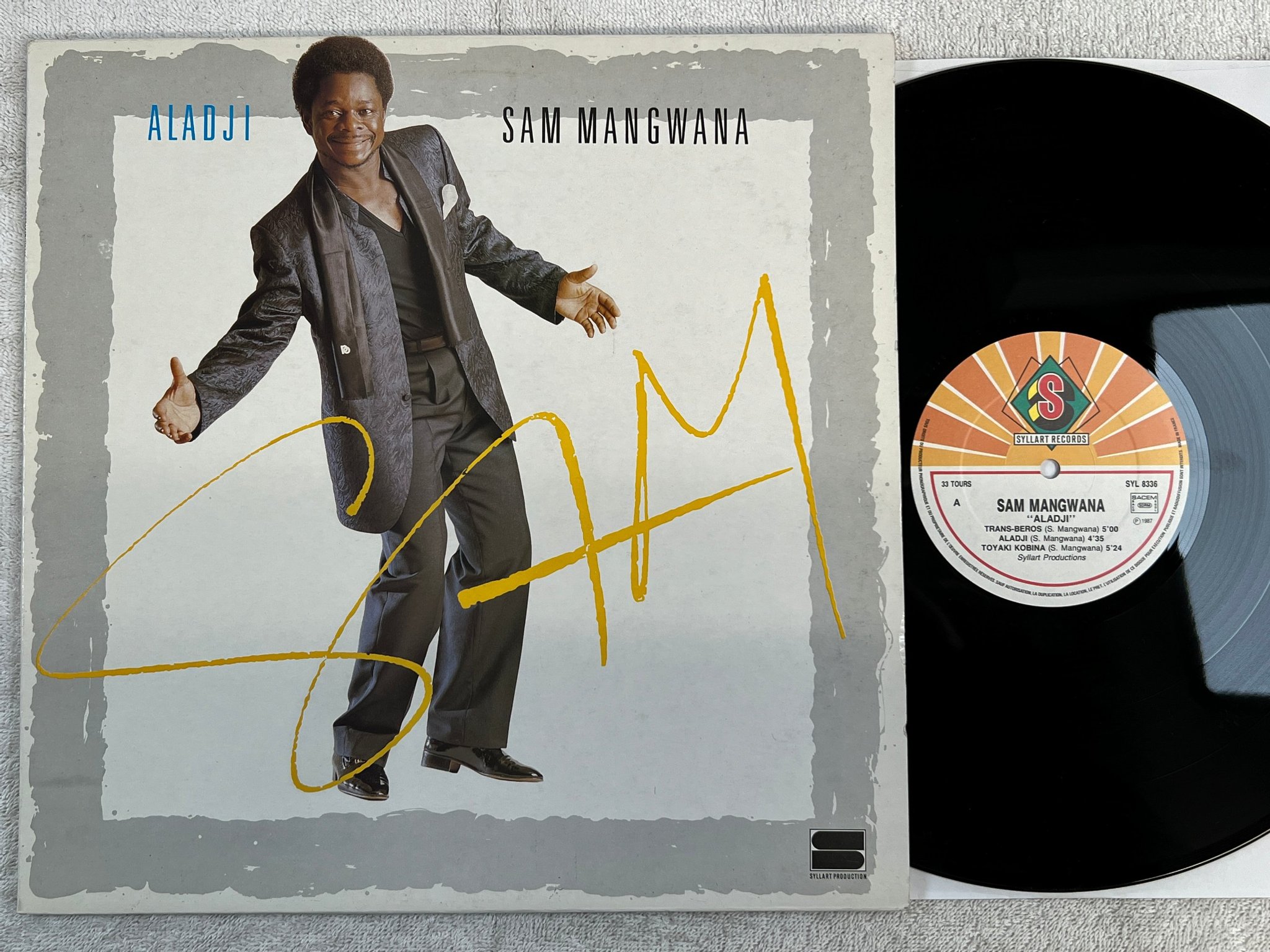 Omslagsbild för skivan SAM MANGWANA aladji LP -87 Fra SYLLART SYL 8336