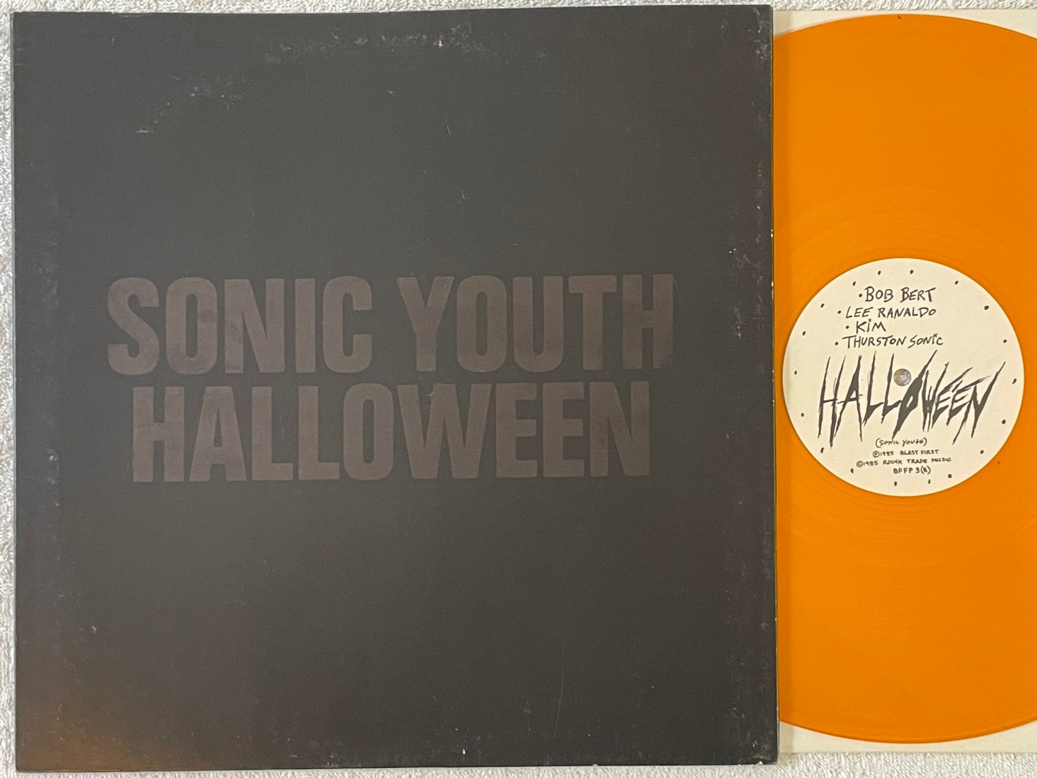 Omslagsbild för skivan SONIC YOUTH Flower  12"single -86 UK BLAST FIRST BFFP-3 orange vinyl
