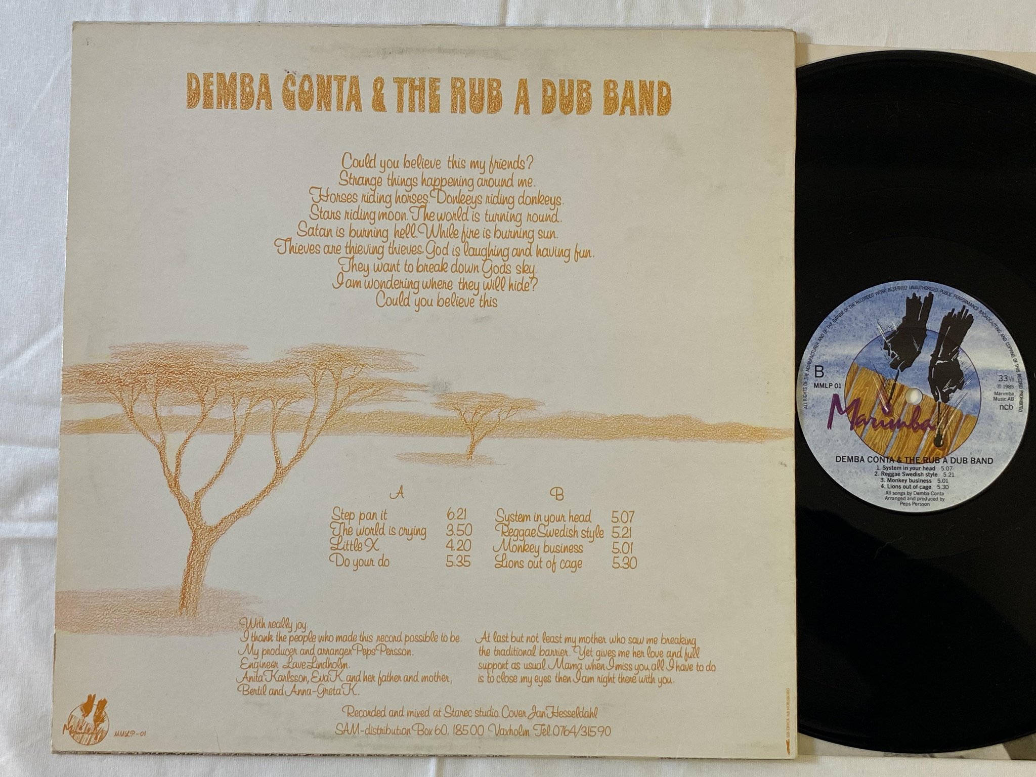 Omslagsbild för skivan DEMBA CONTA & THE RUB A DUB BAND monkey business LP -85 ncb MARIMBA MMLP 01