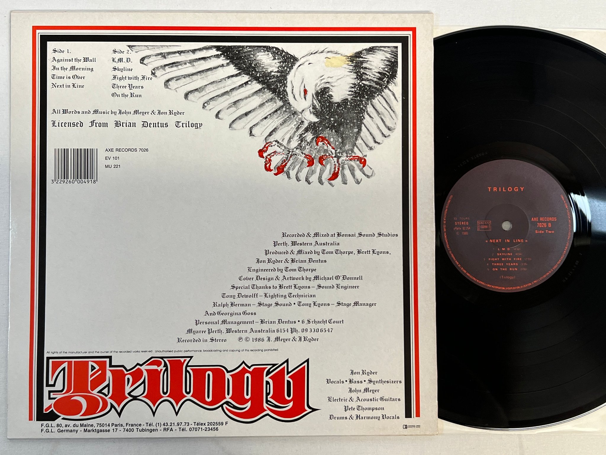 Omslagsbild för skivan TRILOGY next in time LP -86 Fra AXE 7026 ** VERY RARE HARD ROCK **