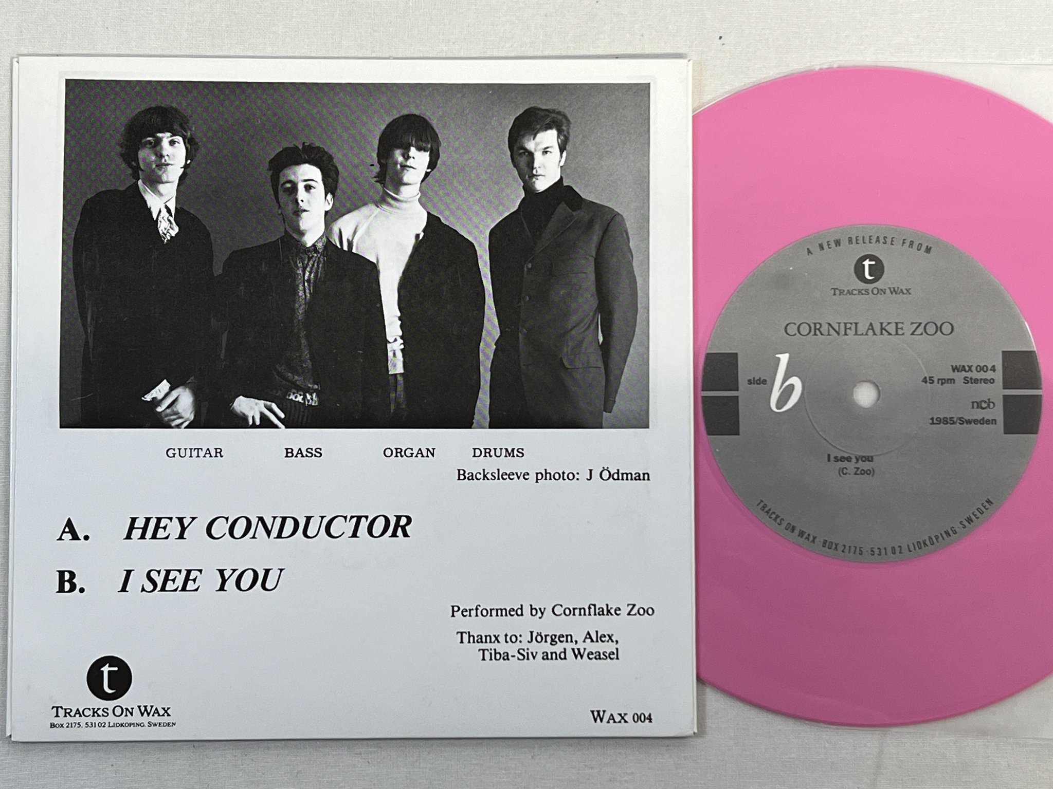 Omslagsbild för skivan CORNFLAKE ZOO hey conductor 7" -85 Swe TRACKS ON WAX WAX 004 ** PINK VINYL **