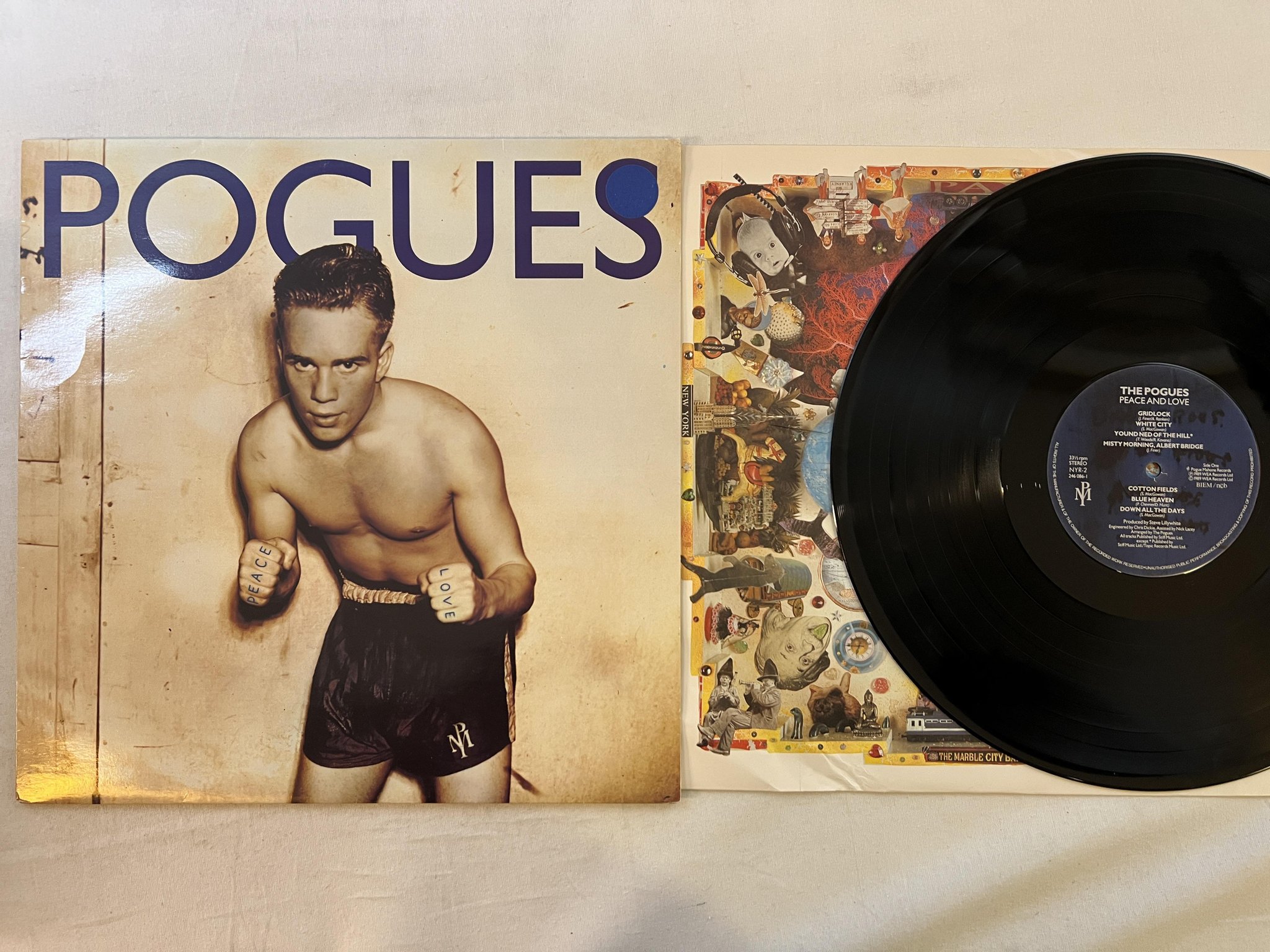 Omslagsbild för skivan THE POGUES peace and love LP -89 ncb POGUE MAHONE NYR-2