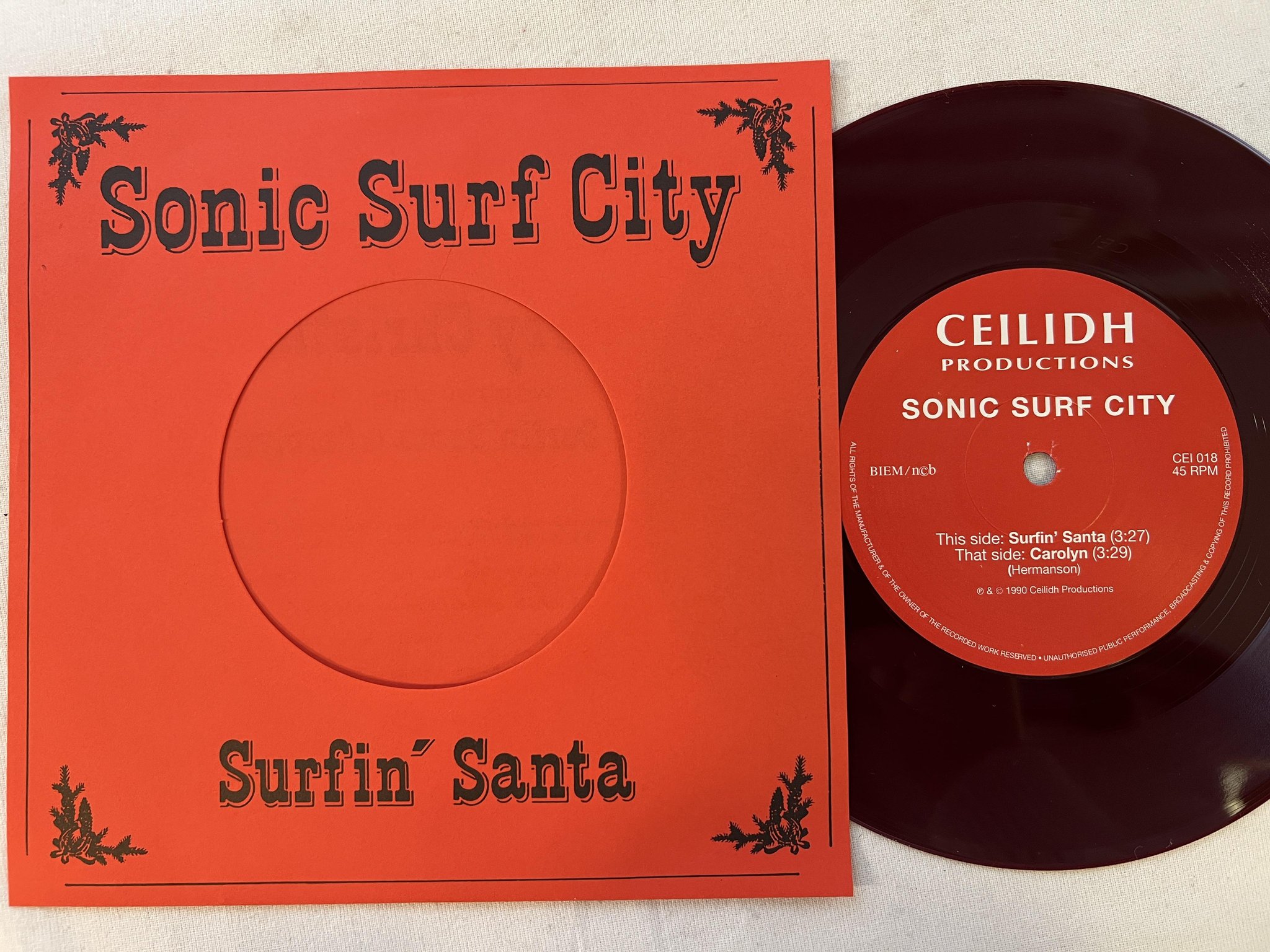 Omslagsbild för skivan SONIC SURF CITY surfin santa 7"single -90 Swe CEILIDH CEI 018 * red vinyl *