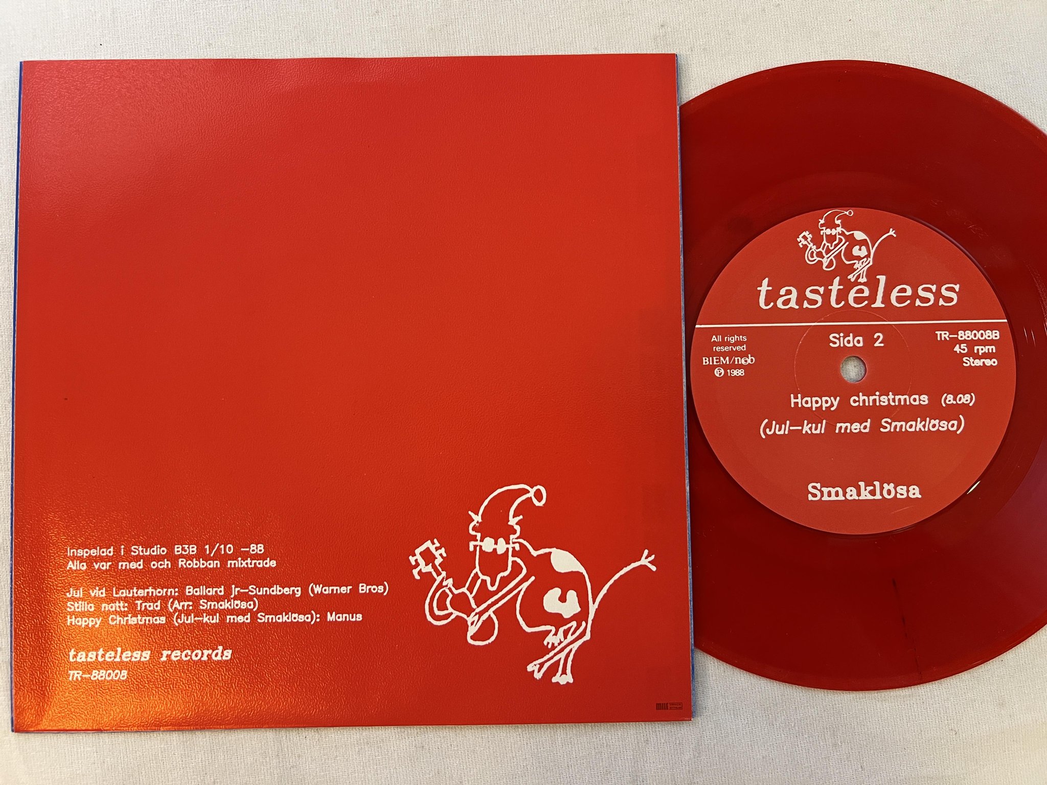 Omslagsbild för skivan SMAKLÖSA Jul Med Smaklösa 7"single -88 Swe TASTELESS TE-88008 ** RED VINYL **