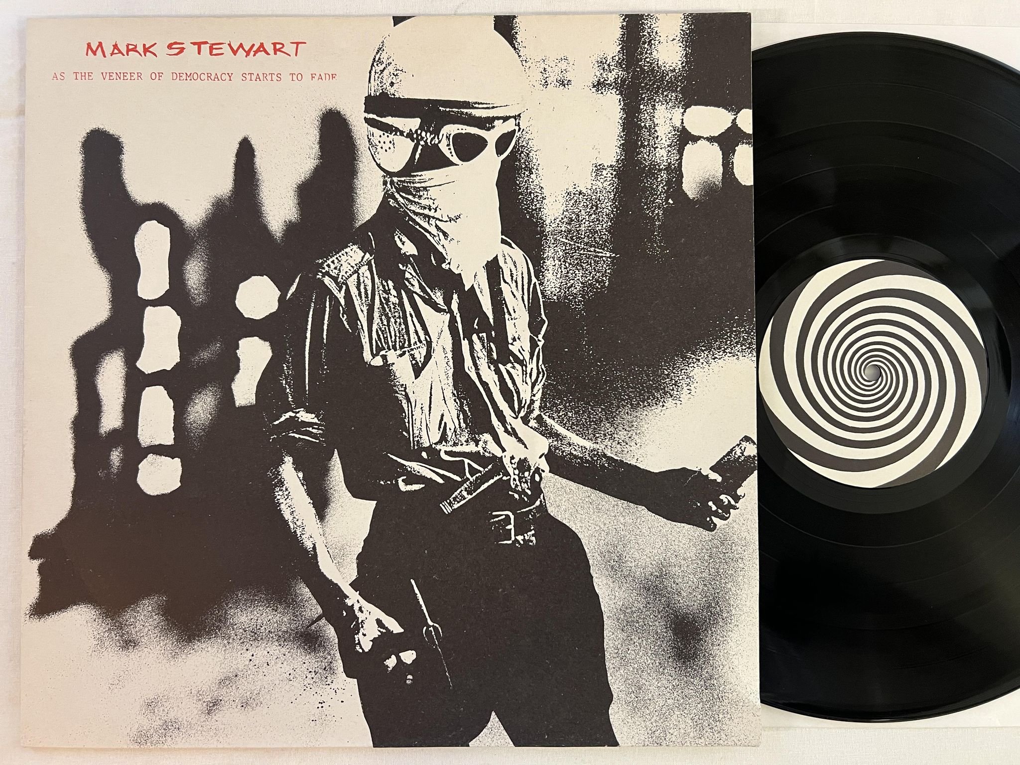 Omslagsbild för skivan MARK STEWART as the veneer of democracy starts to fade LP -85 UK STUMM 24