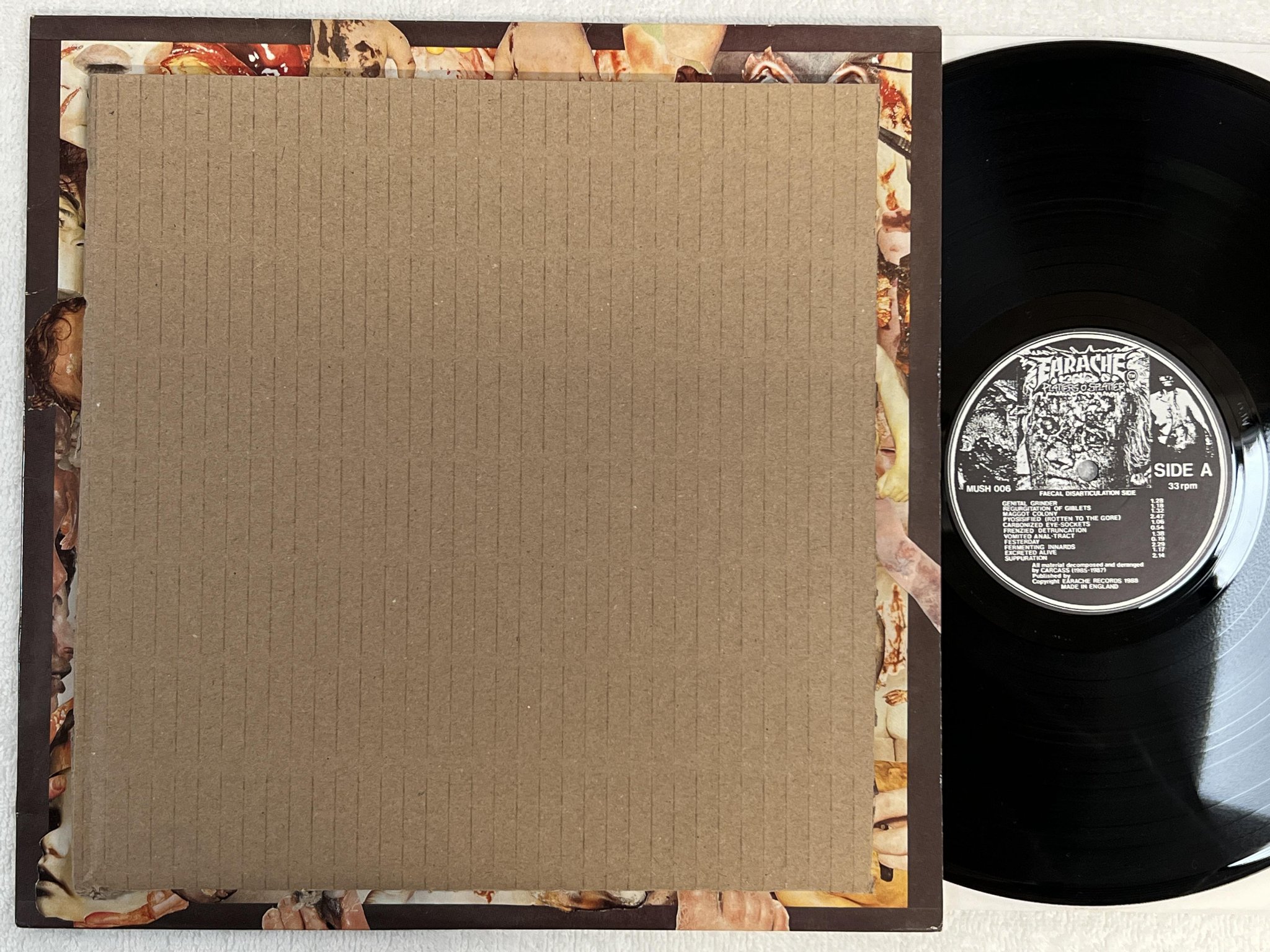 Omslagsbild för skivan CARCASS Reek Of Putrefaction LP -88 UK EARACHE Mosh 25