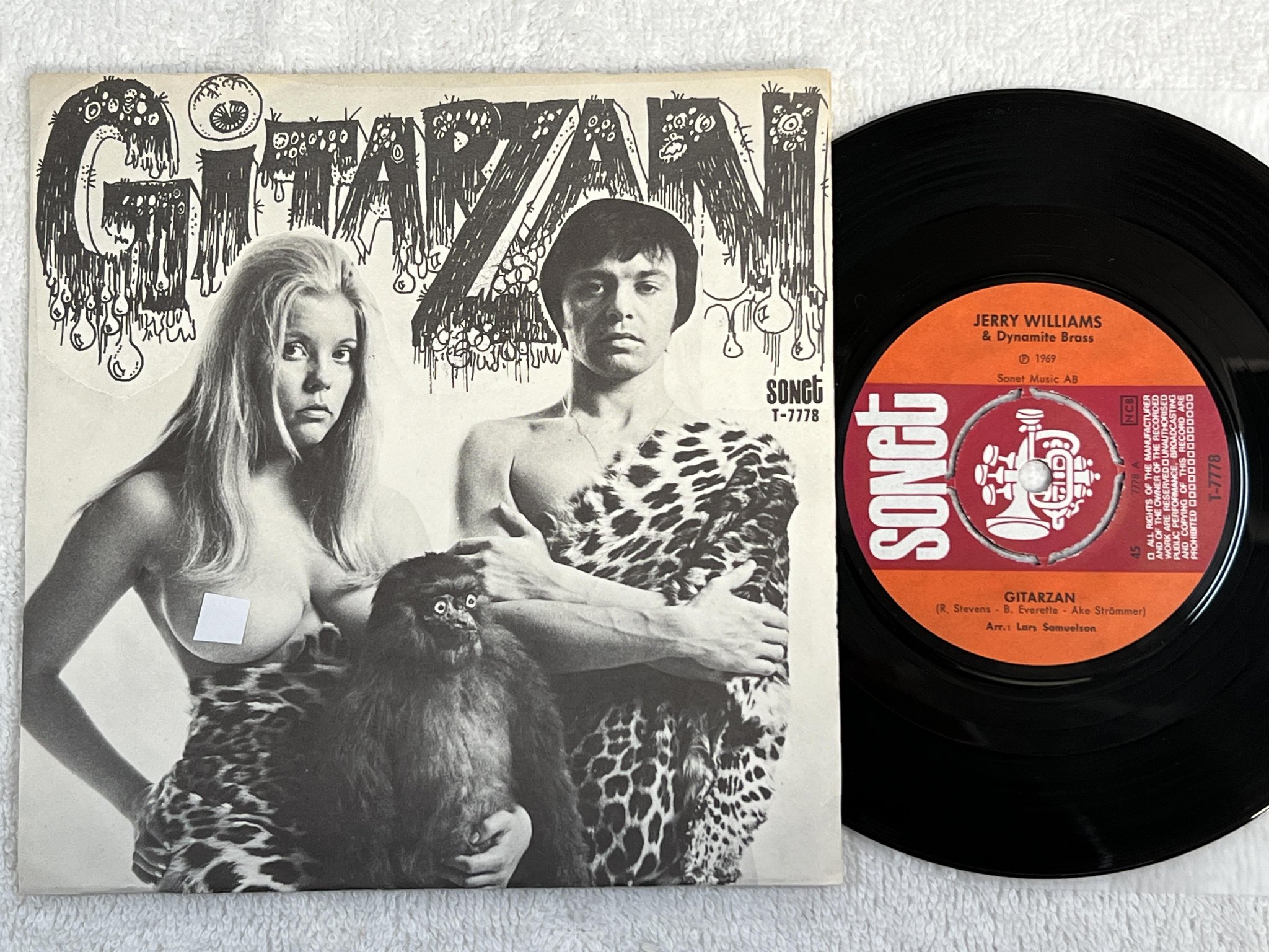 Omslagsbild för skivan JERRY WILLIAMS & DYNAMITE BRASS Gitarzan 7" -69 SONET T-7778