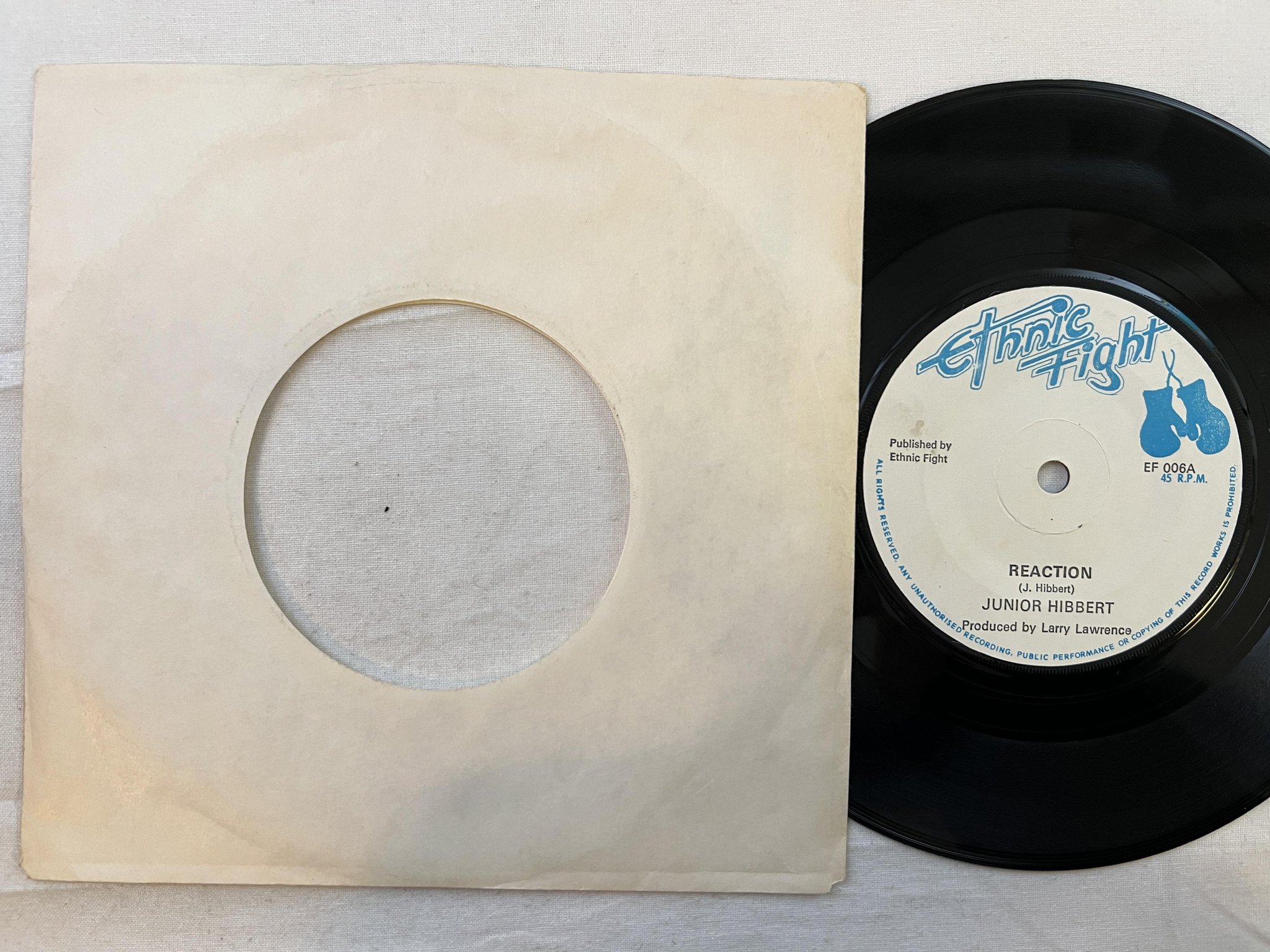 Omslagsbild för skivan JUNIOR HIBBERT reaction 7" -75 UK ETHNIC FIGHT EF 006