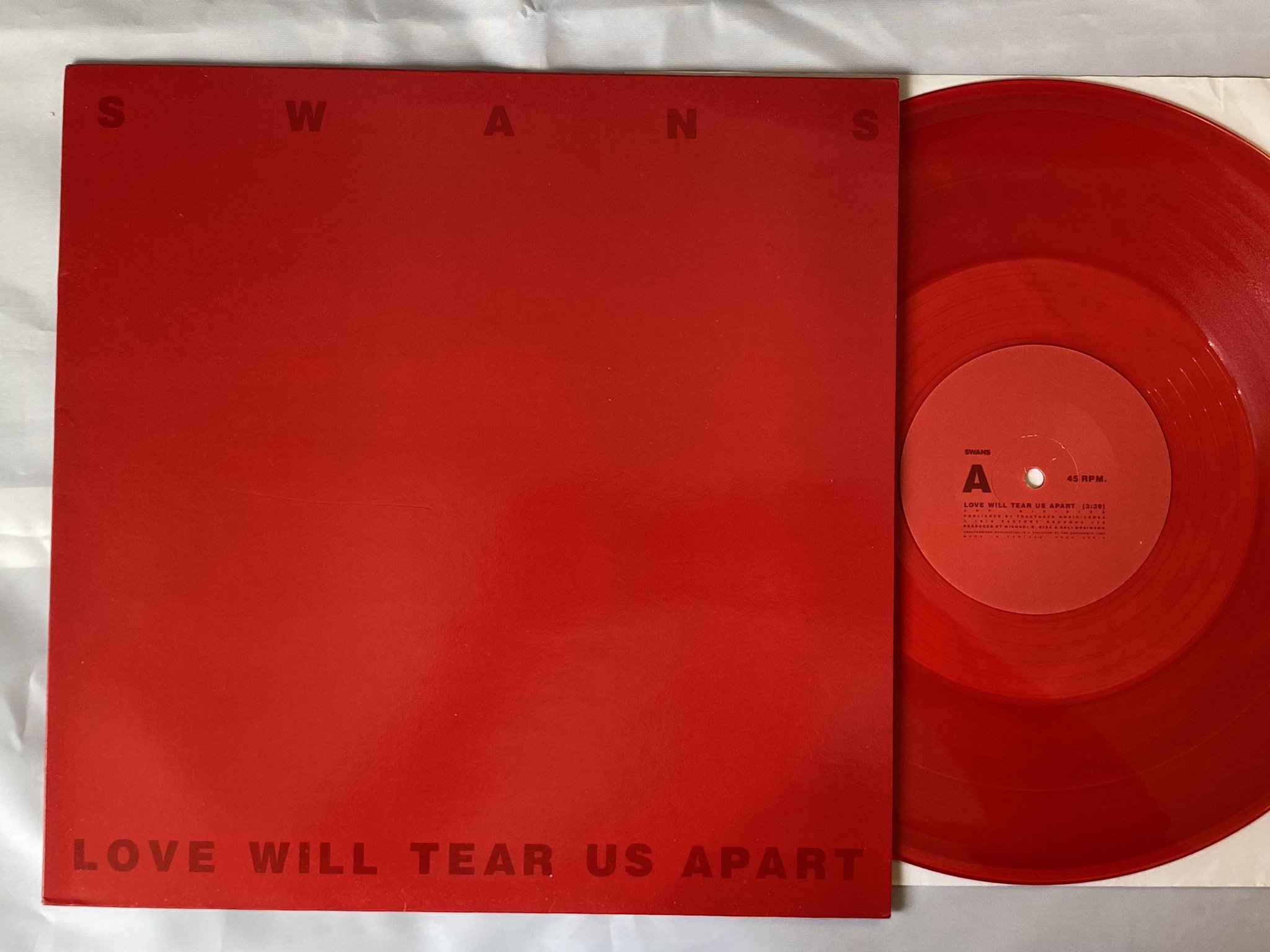 Omslagsbild för skivan SWANS Love Will Tear Us Apart 12"single -88 UK PROD 23 R *** RED VINYL ***