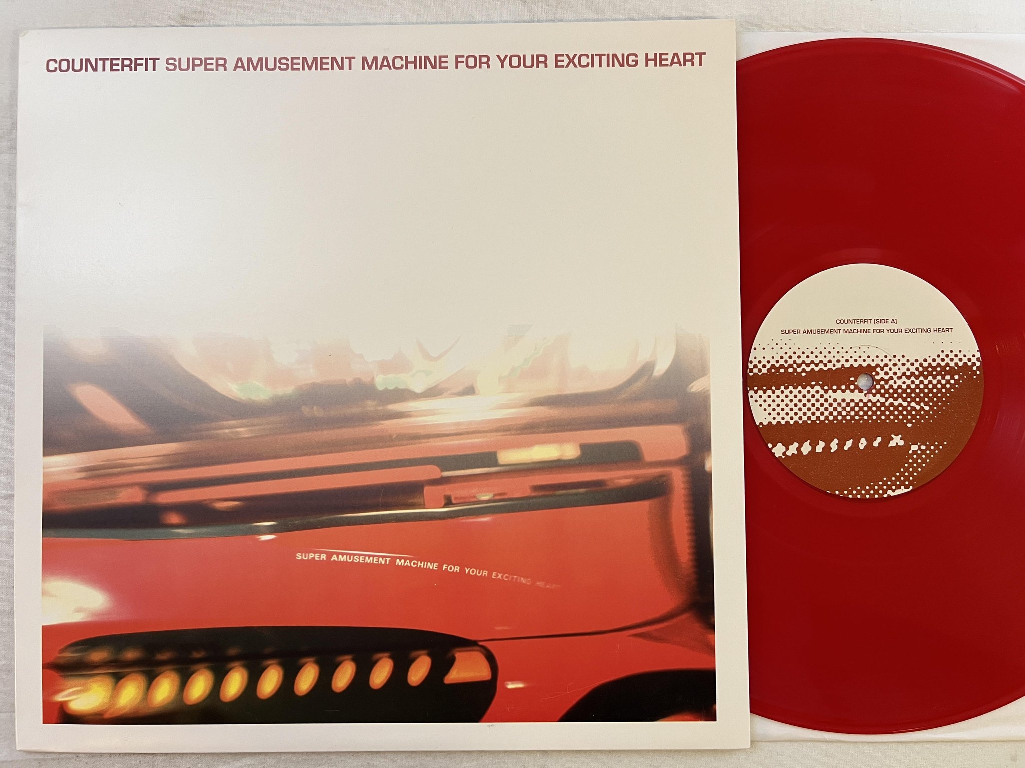 Omslagsbild för skivan COUNTERFIT Super Amusement Machine For Your Exciting Heart LP US ** RED VINYL **