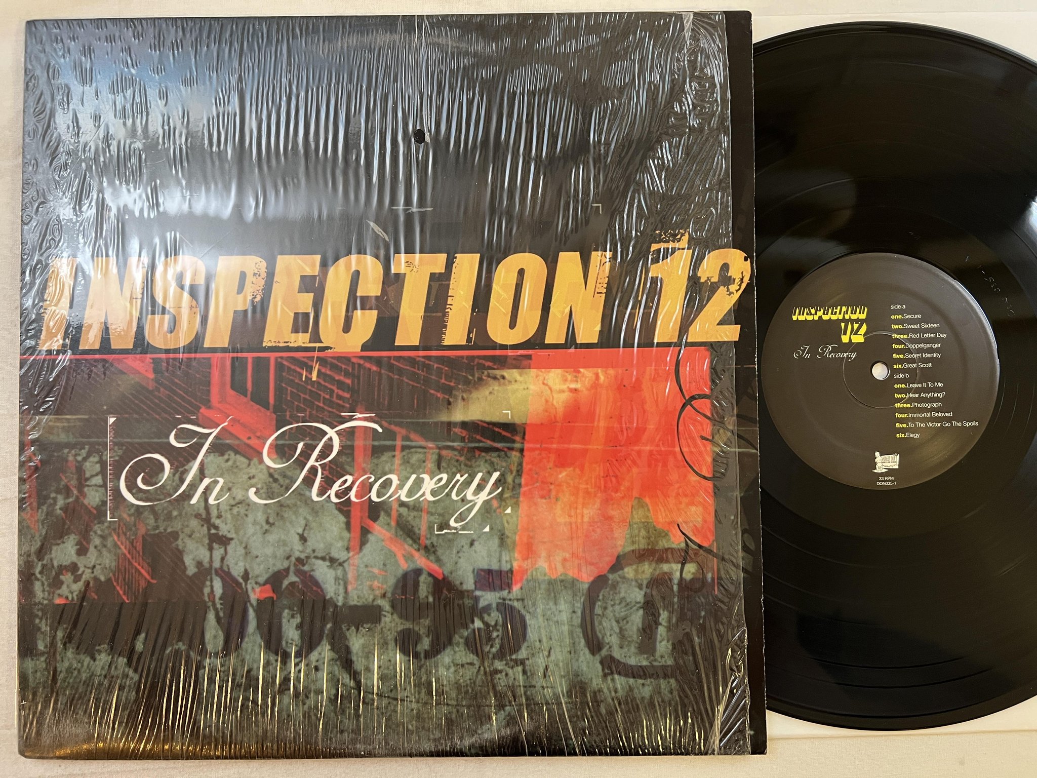 Omslagsbild för skivan INSPECTION 12 In Recovery LP 2001 US HONEST DON'S DON035-1