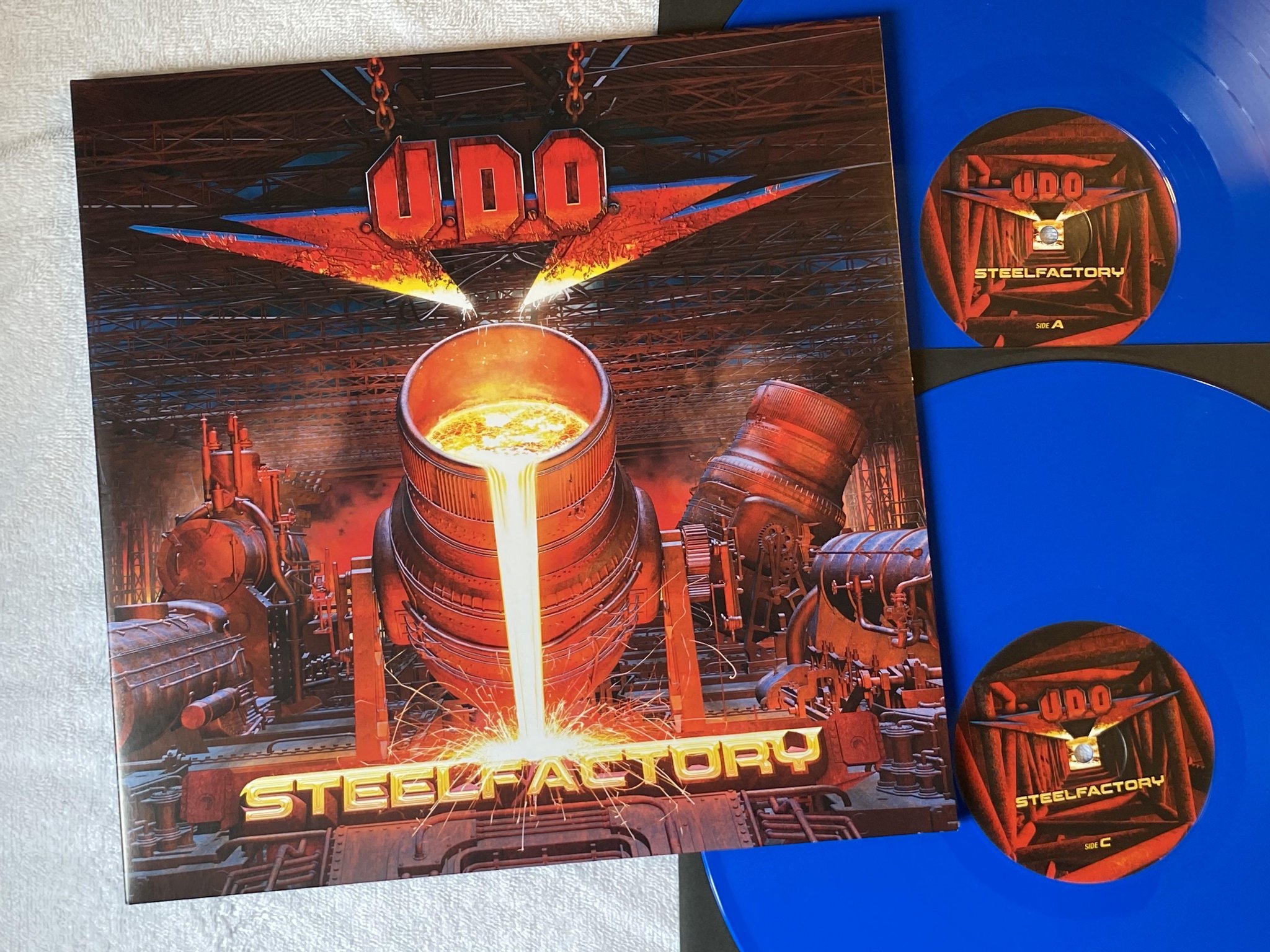 Omslagsbild för skivan U.D.O. Steelfactory 2xLP 2018 Swe AFM 613-1 *** BLUE VINYL ***