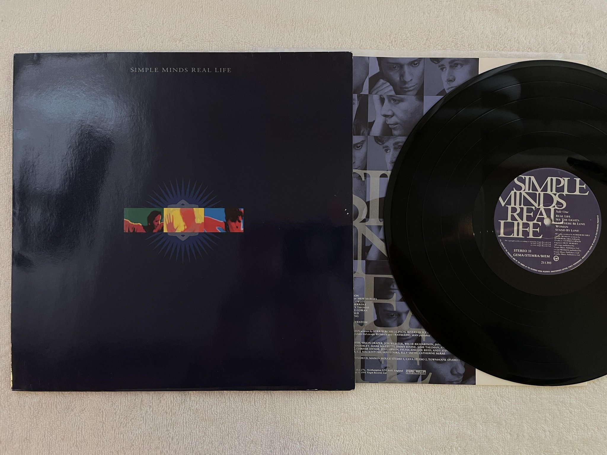Omslagsbild för skivan SIMPLE MINDS real life LP -91 VIRGIN 211393