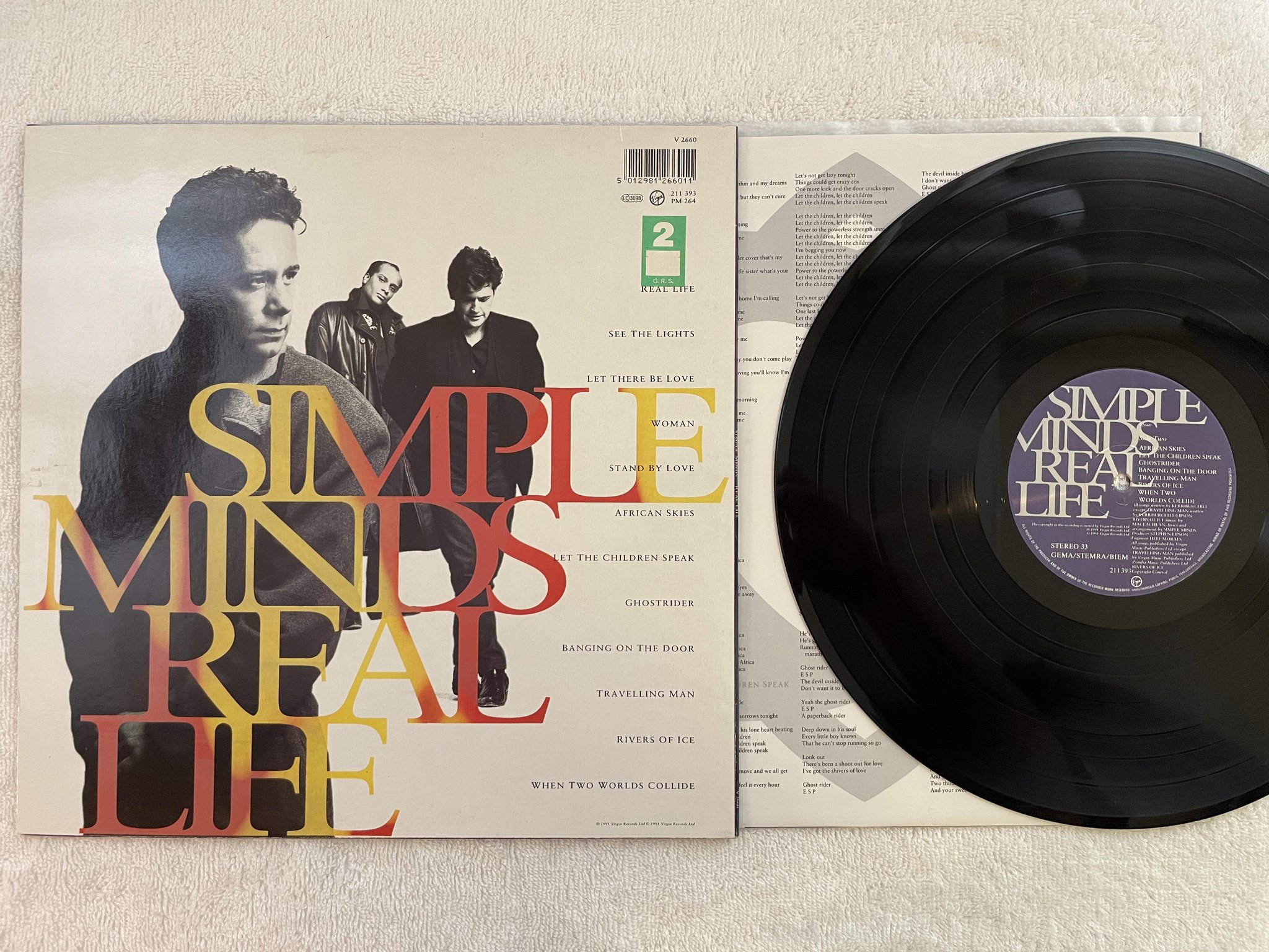 Omslagsbild för skivan SIMPLE MINDS real life LP -91 VIRGIN 211393