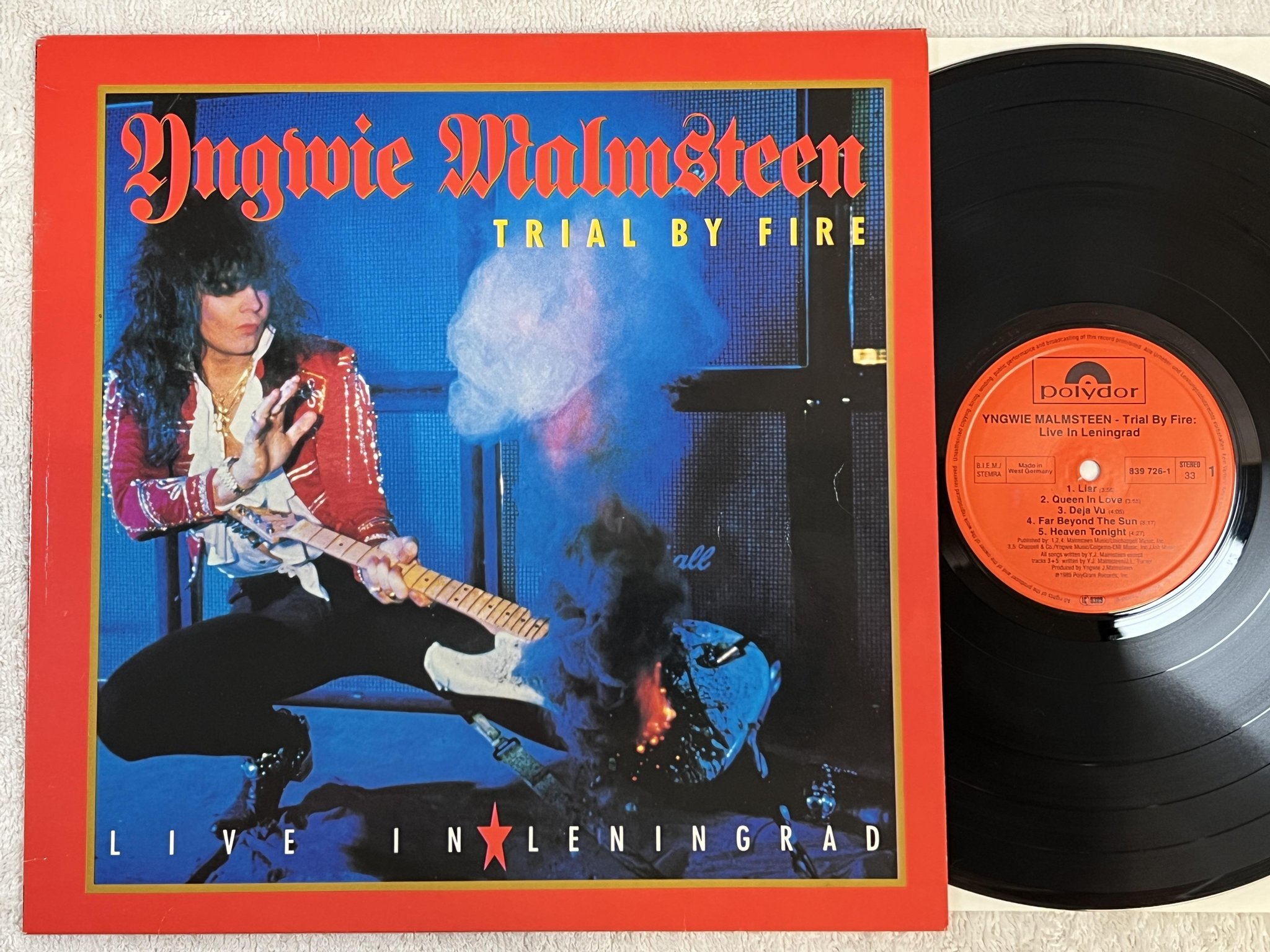 Omslagsbild för skivan YNGWIE MALMSTEEN trial by fire LP -89 Ger POLYDOR 839 726-1