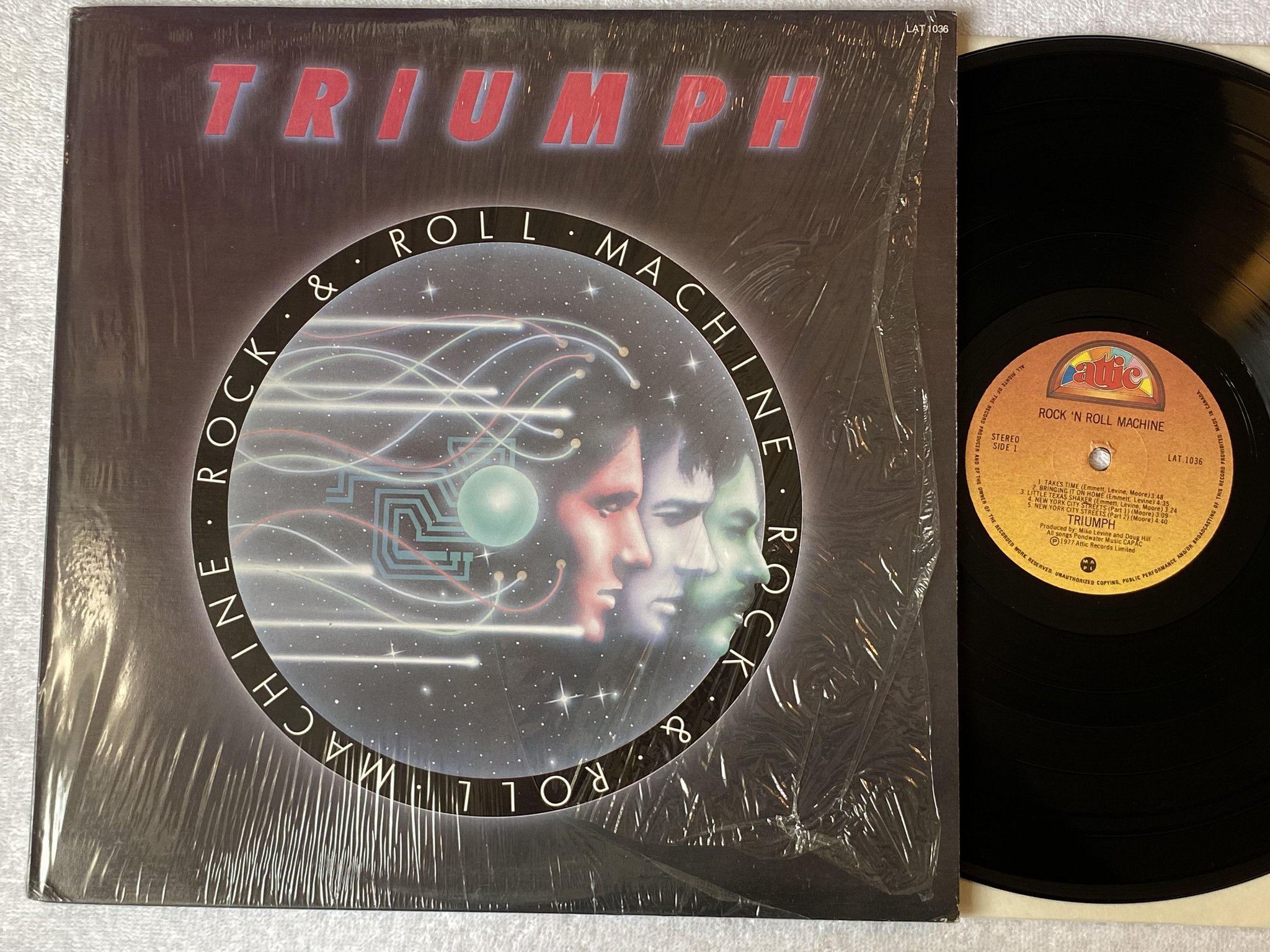 Omslagsbild för skivan TRIUMPH rock n roll machine LP -77 Can ATTIC LAT 1036