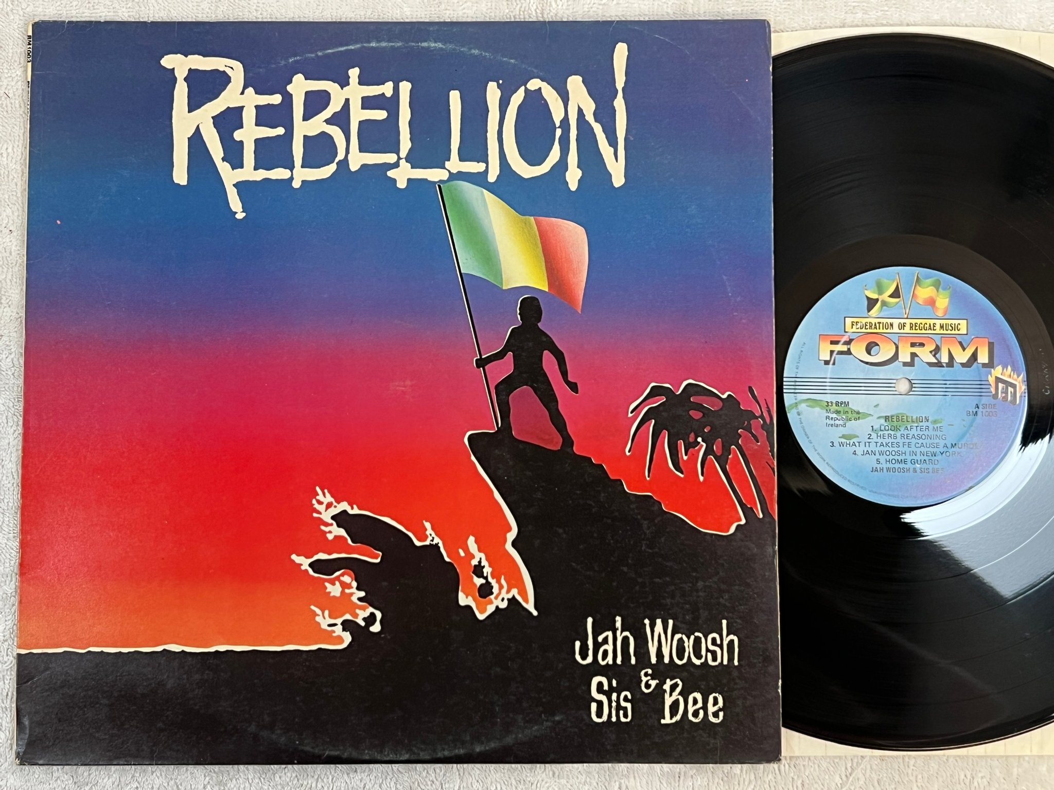 Omslagsbild för skivan JAH WOOSH & SIS BEE rebellion LP -81 FORM BM 1003