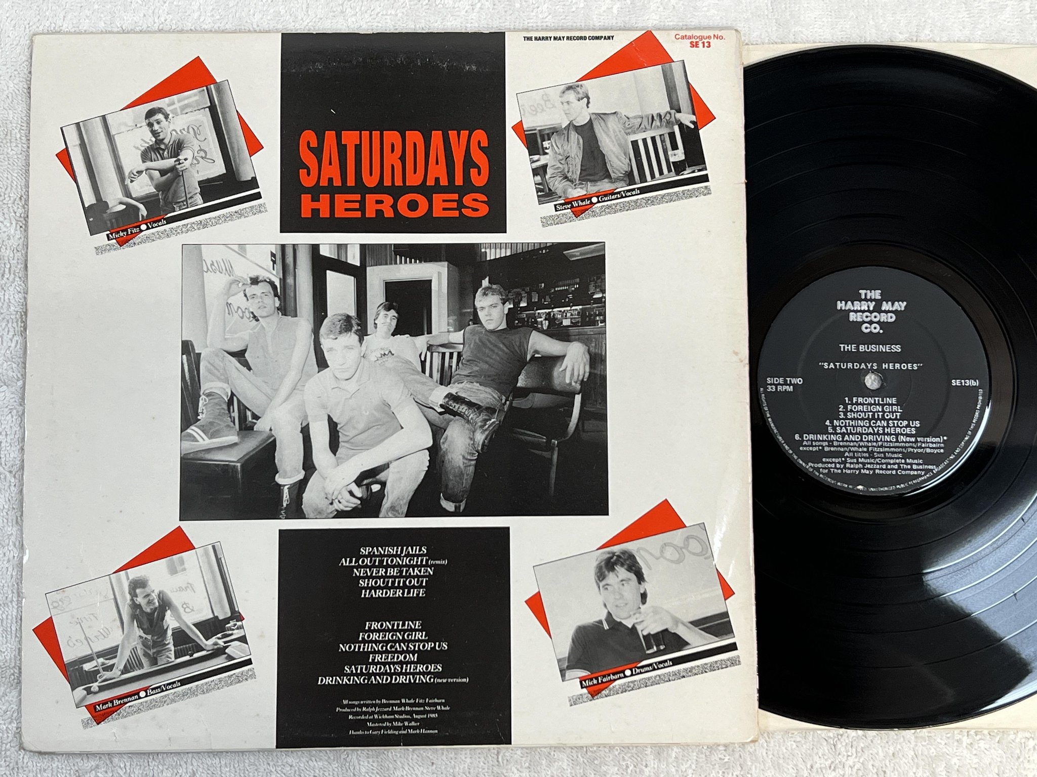 Omslagsbild för skivan THE BUSINESS Saturdays heroes LP -85 UK HARRY MAY SE-13 *** P U N K ***