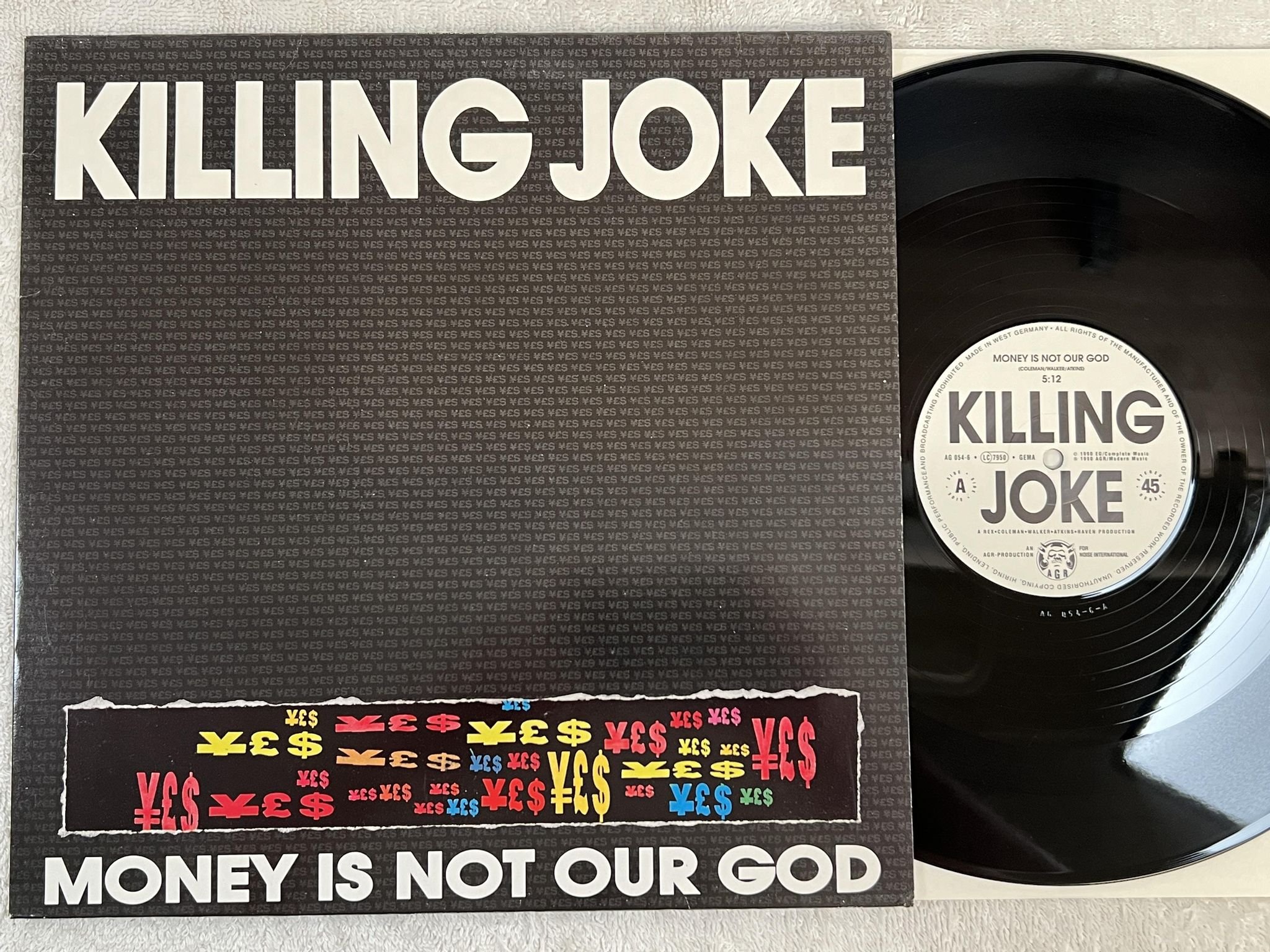 Omslagsbild för skivan KILLING JOKE money is not your god 12" -90 Ger AGR AG 054-6