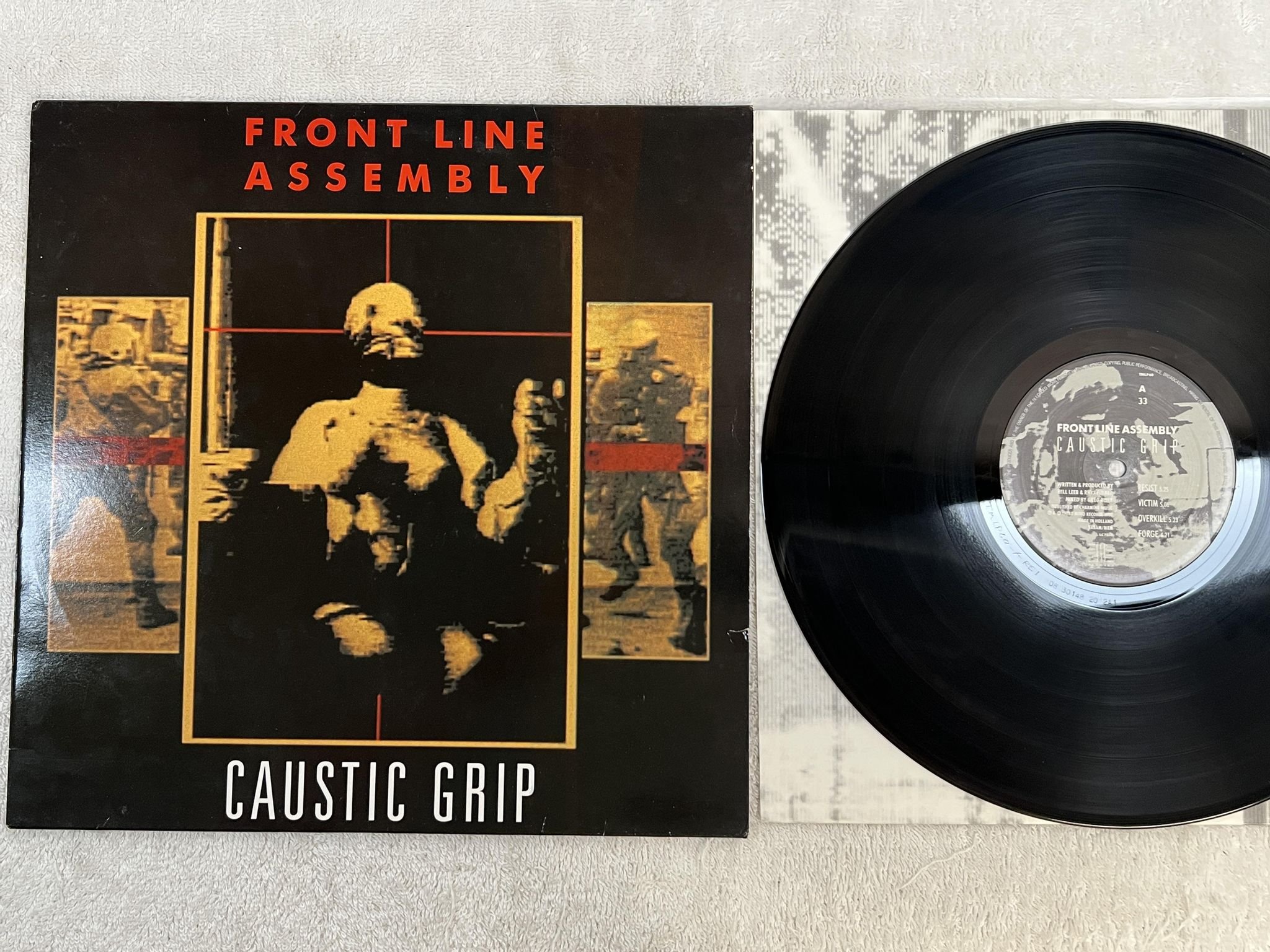 Omslagsbild för skivan FRONT LINE ASSEMBLEY Caustic Grip LP -90 Hol THIRD MIND TMLP 60