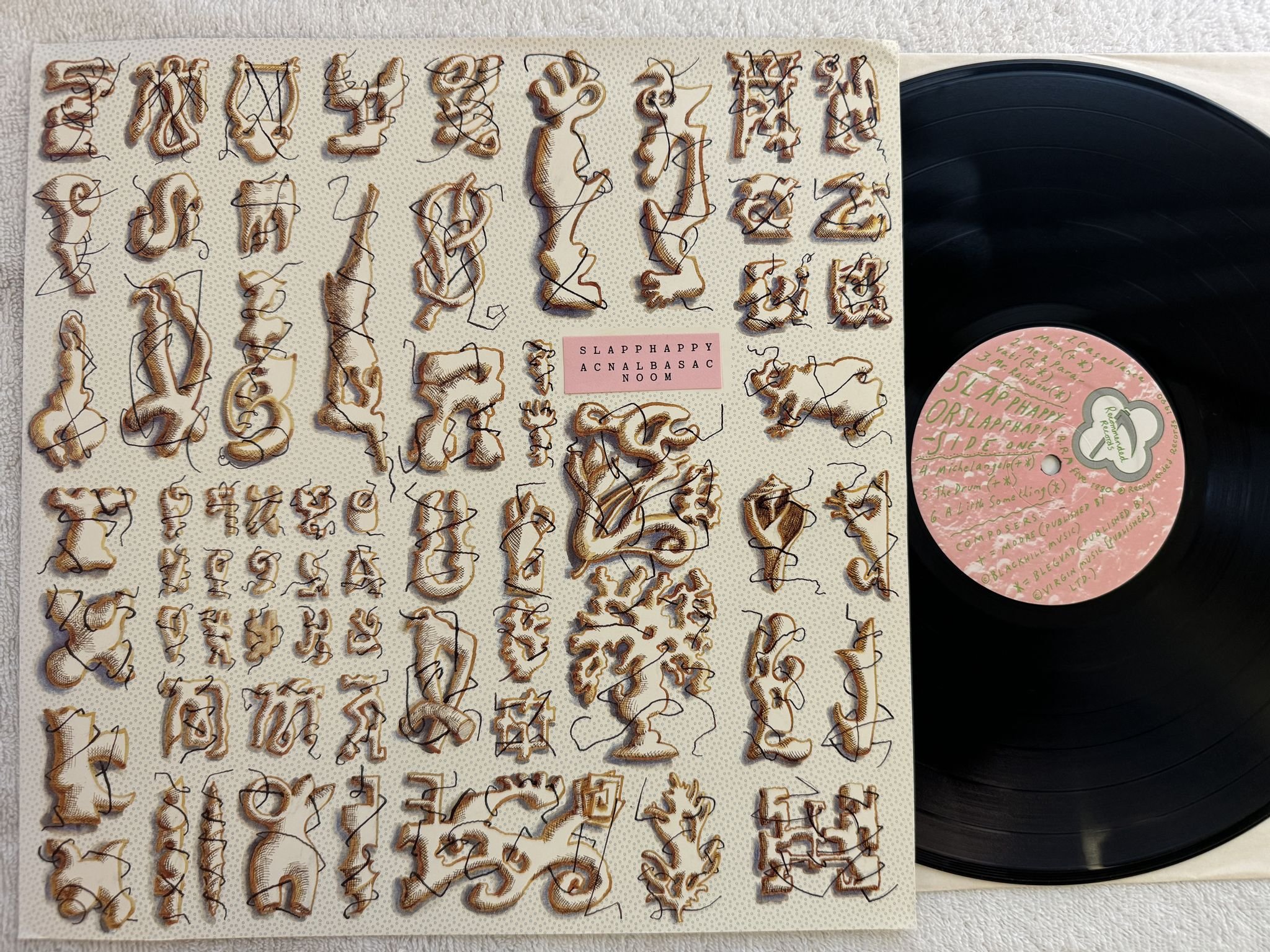 Omslagsbild för skivan SLAPP HAPPY Acnalbasac Noom LP -82 UK recommended R.R. five