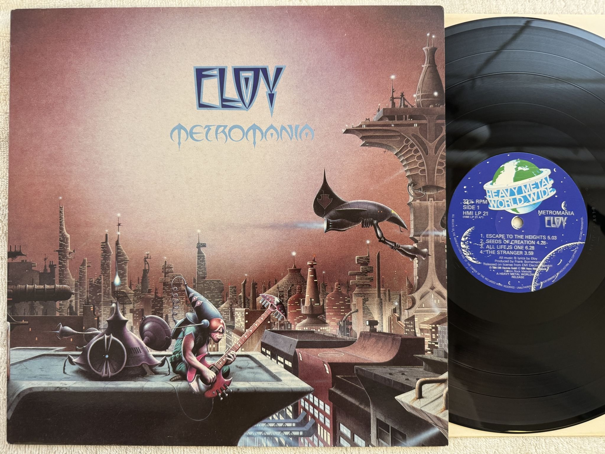 Omslagsbild för skivan ELOY metromania LP -84 UK HEAVY METAL WORLD WIDE HMI LP 21