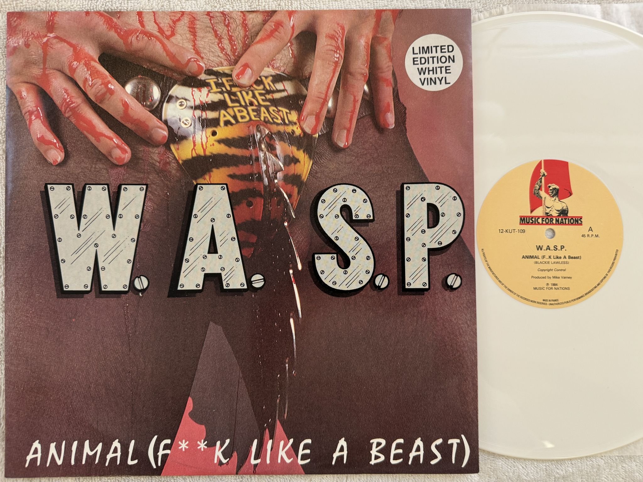 Omslagsbild för skivan W.A.S.P. animal 12" -84 UK MUSIC FOR NATION 12 KUT 109 *** WHITE VINYL ***