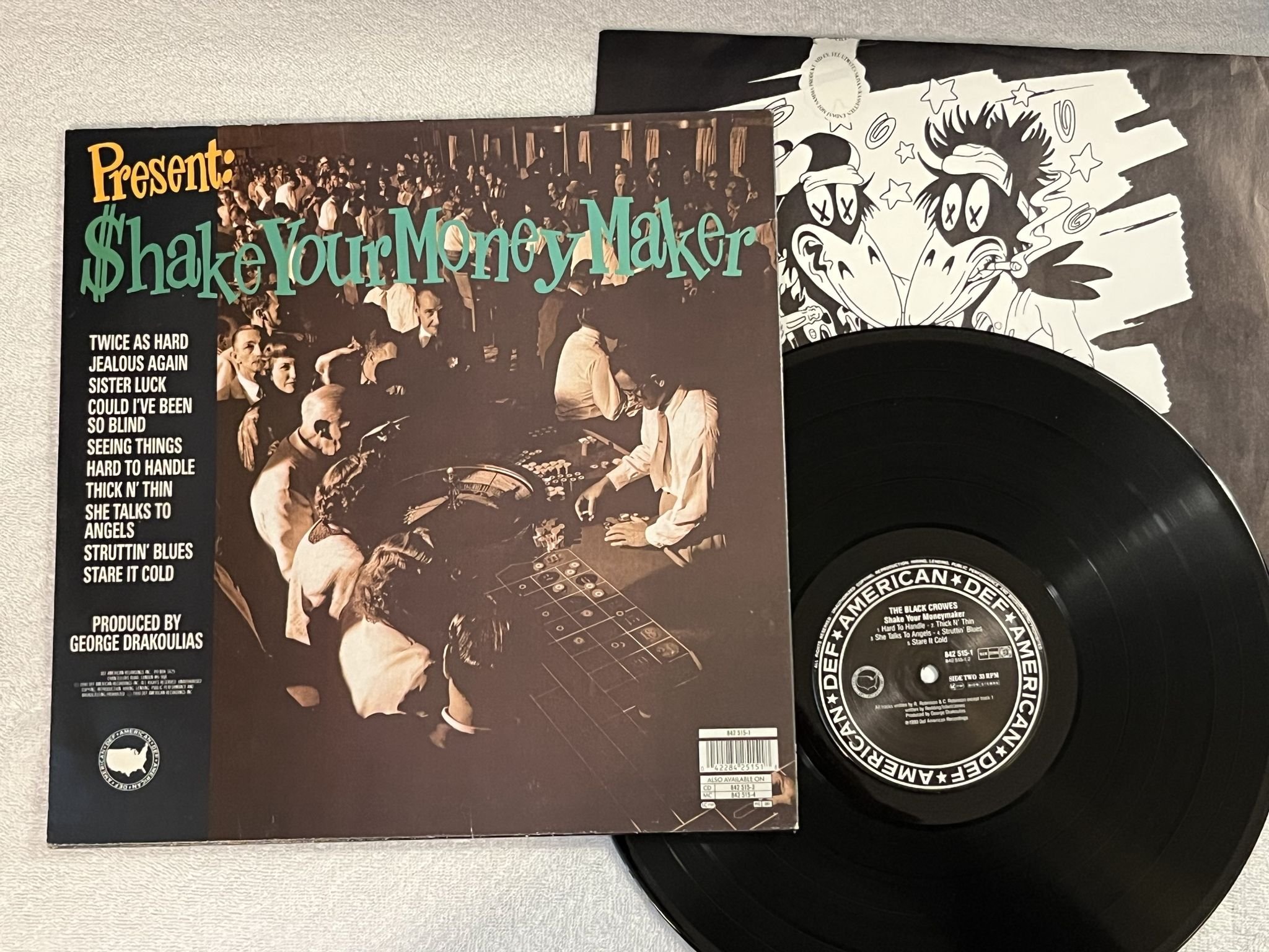 Omslagsbild för skivan THE BLACK CROWES Shake Your Money Maker LP -90 def americans 842 515-1