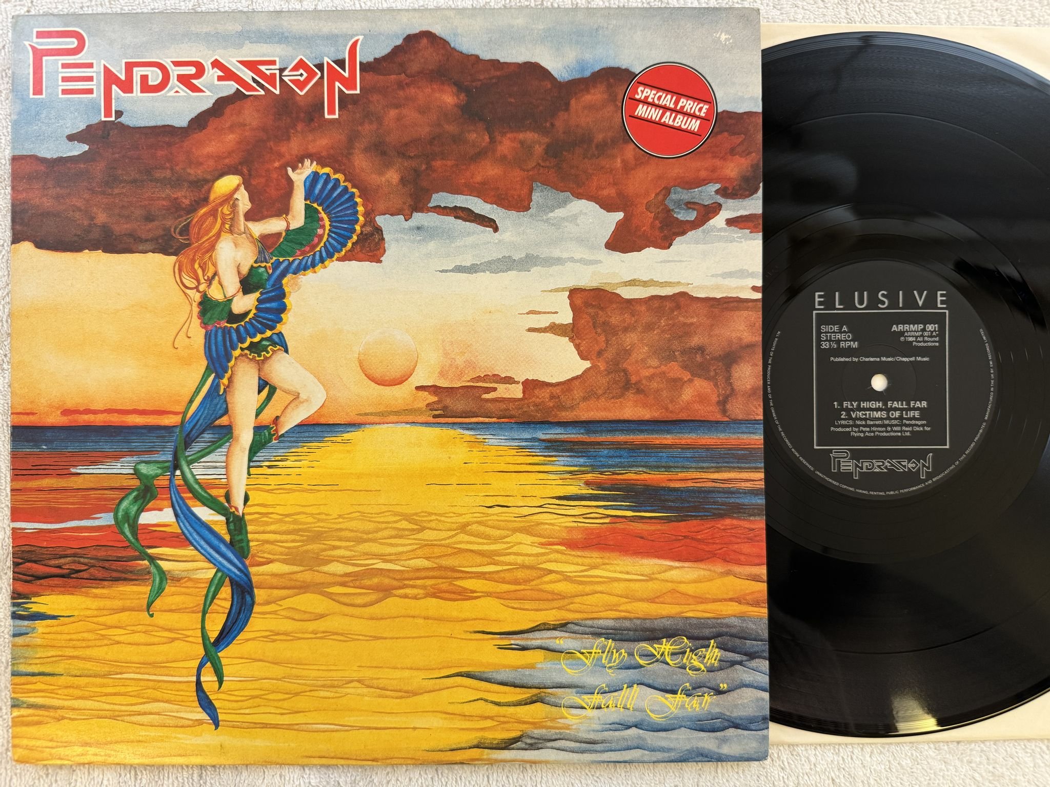 Omslagsbild för skivan PENDRAGON Fly High Fall Far LP -84 UK ELUSIVE ARRMP 001