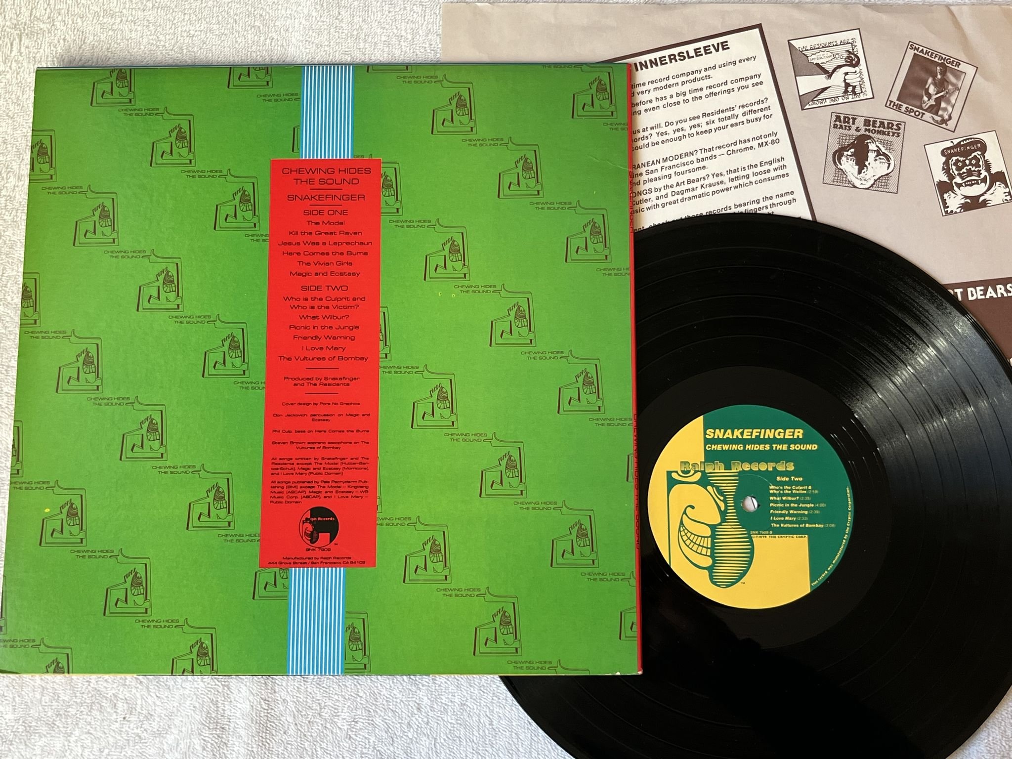 Omslagsbild för skivan SNAKEFINGER Chewing Hides The Sound LP -79 US RALPH SNK 7909
