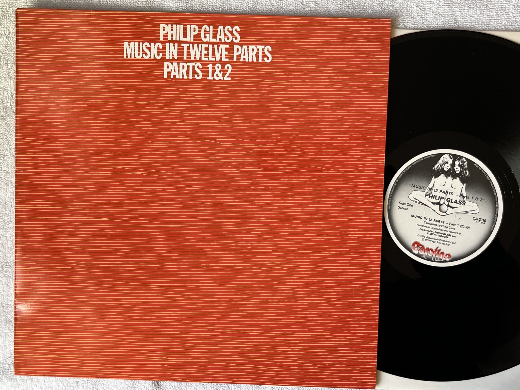 Omslagsbild för skivan PHILIP GLASS music in 12 parts pt I & pt II LP -76 CAROLINE CA 2010