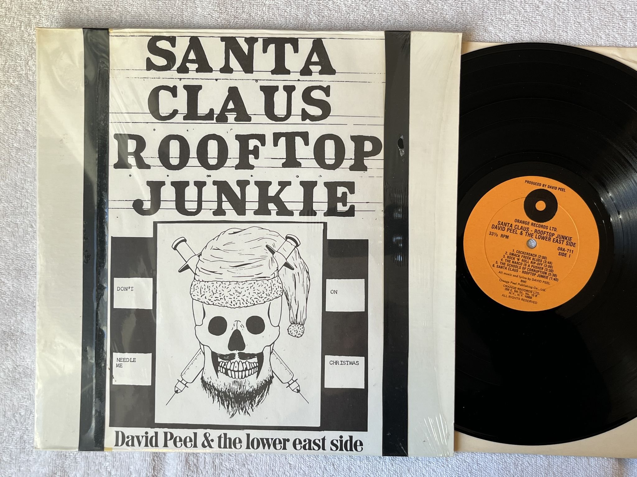Omslagsbild för skivan DAVID PEEL Santa Claus - Rooftop Junkie LP -74 US ORANGE ORA 711