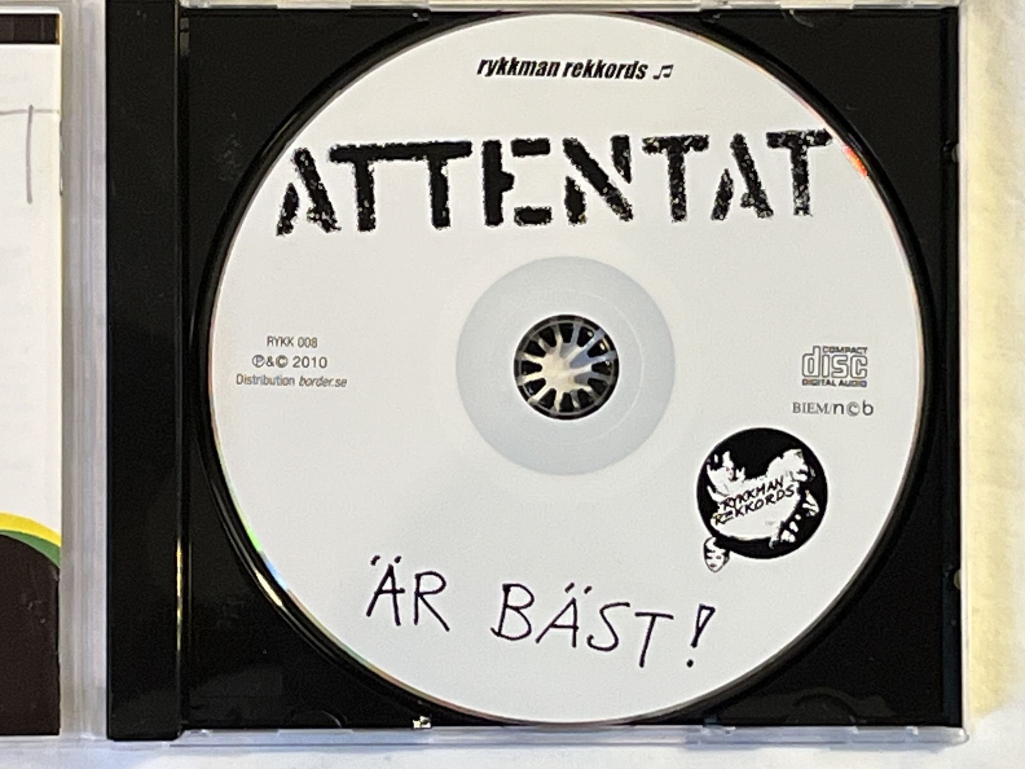 Omslagsbild för skivan ATTENTAT Attentat Är Bäst! CD 2010 RYKKMAN REKKORDS RYKK 008 *** SIGNED ***