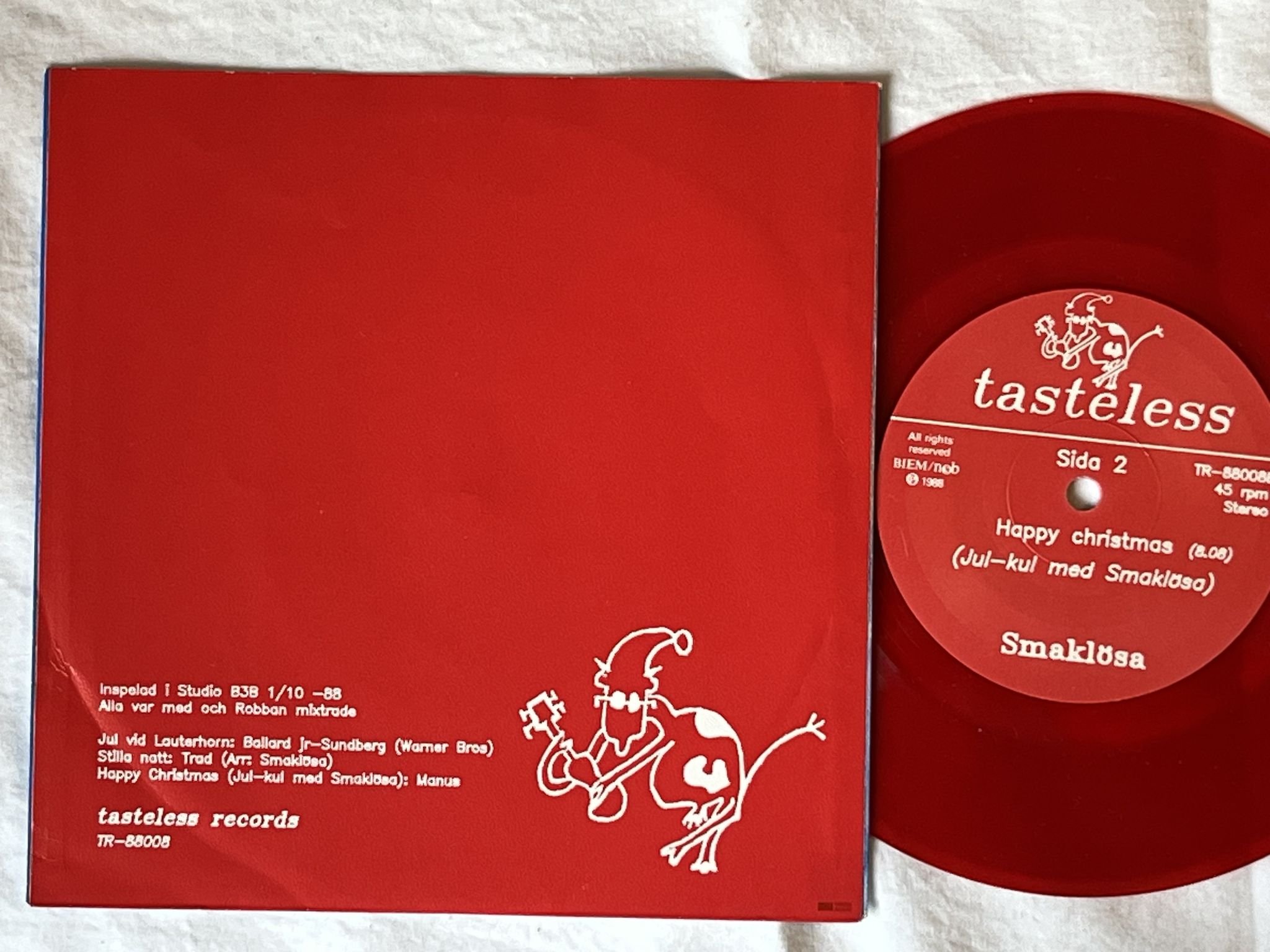 Omslagsbild för skivan SMAKLÖSA Jul Med Smaklösa 7"EP -88 TASTELESS TR-88008 ** RED VINYL **