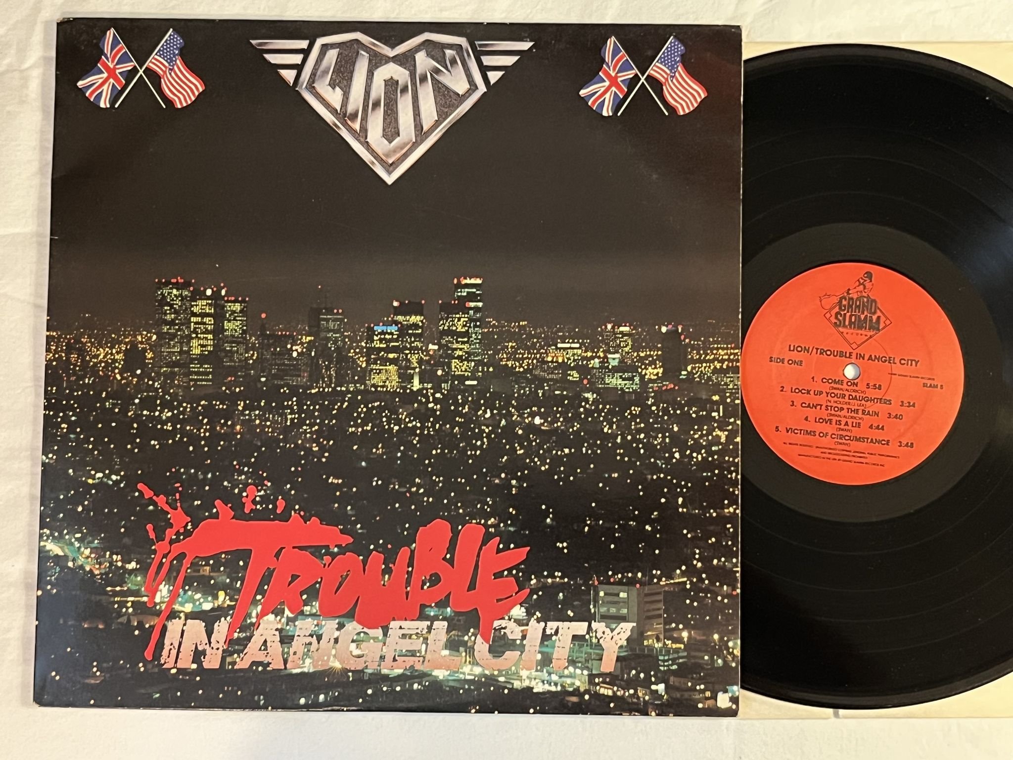 Omslagsbild för skivan LION trouble in angel city LP -89 US GRAND SLAMM SLAM 5