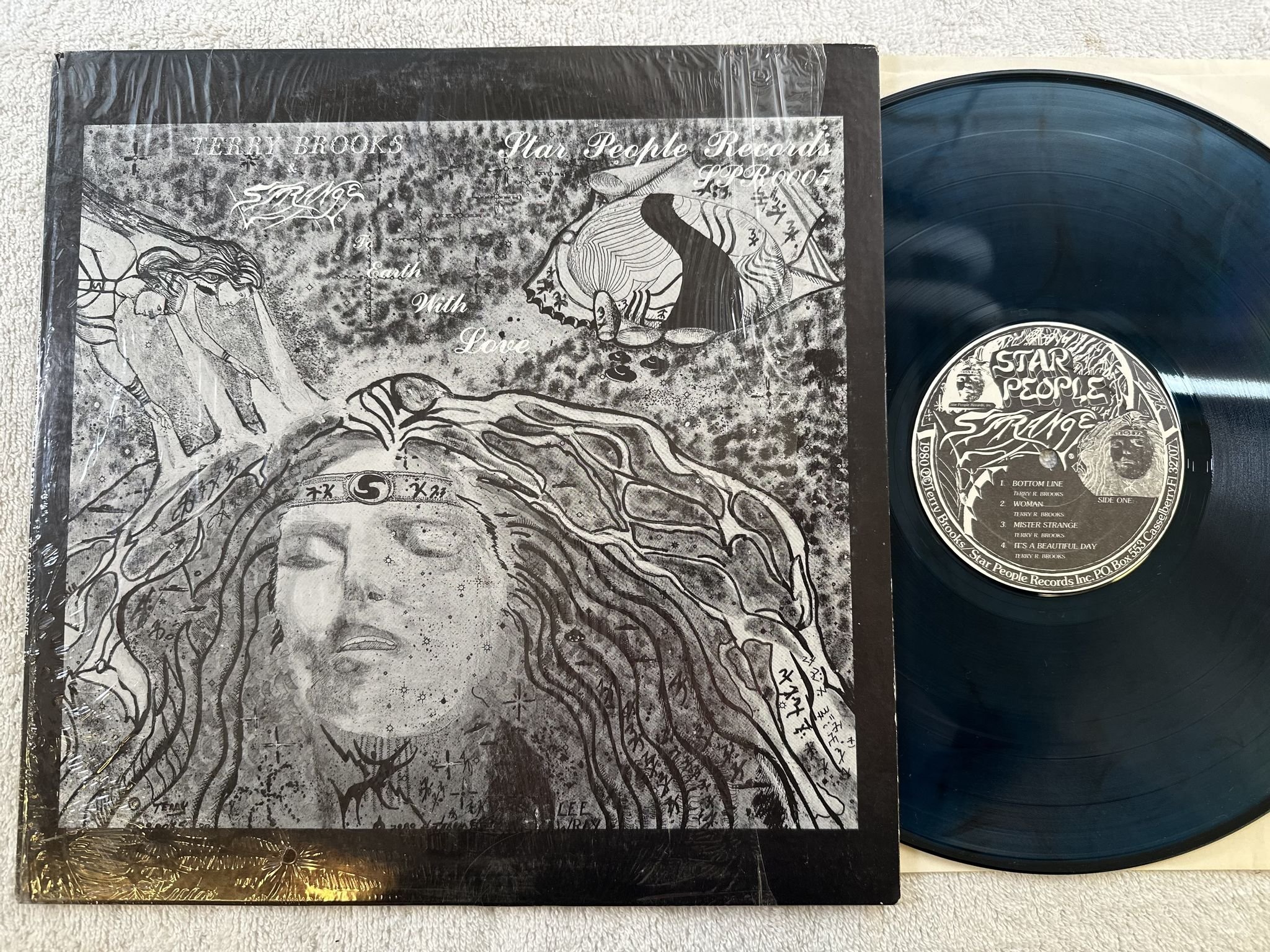 Omslagsbild för skivan TERRY BROOKS & STRANGE To Earth With Love LP -80 STAR PEOPLE ** Blue Vinyl **